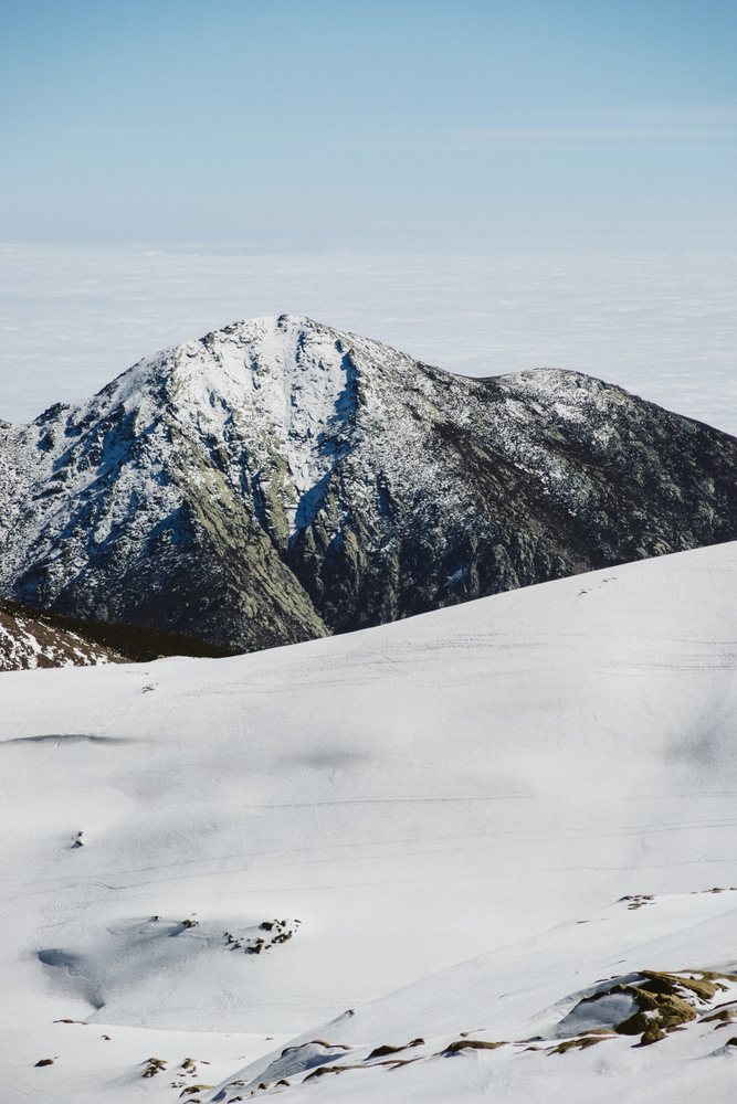 Snow-covered mountain ridge under blue sky