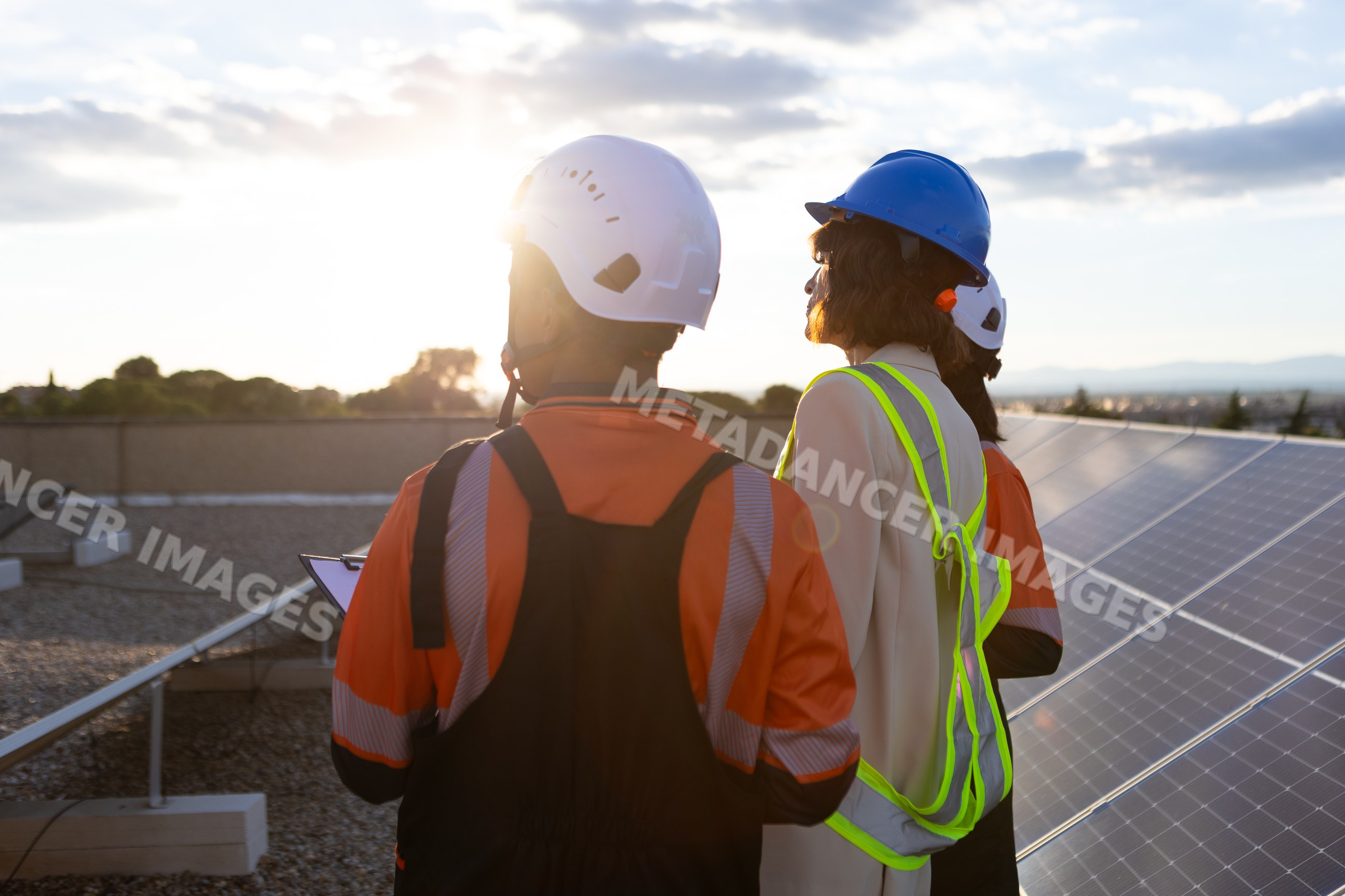 Engineers inspecting solar panels at renewable energy site in Madrid