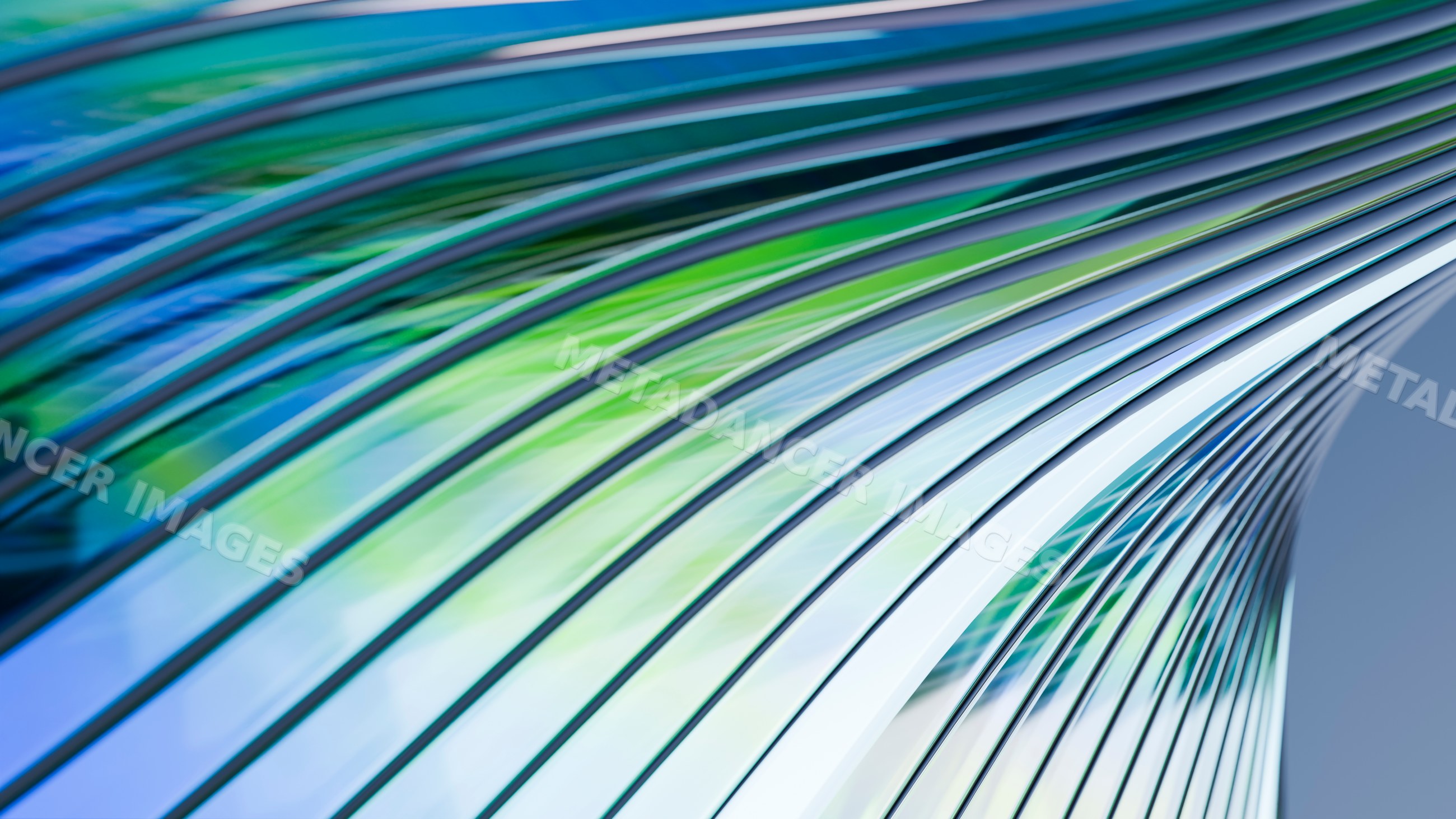 Abstract modern architecture with curved glass panels reflecting blue
