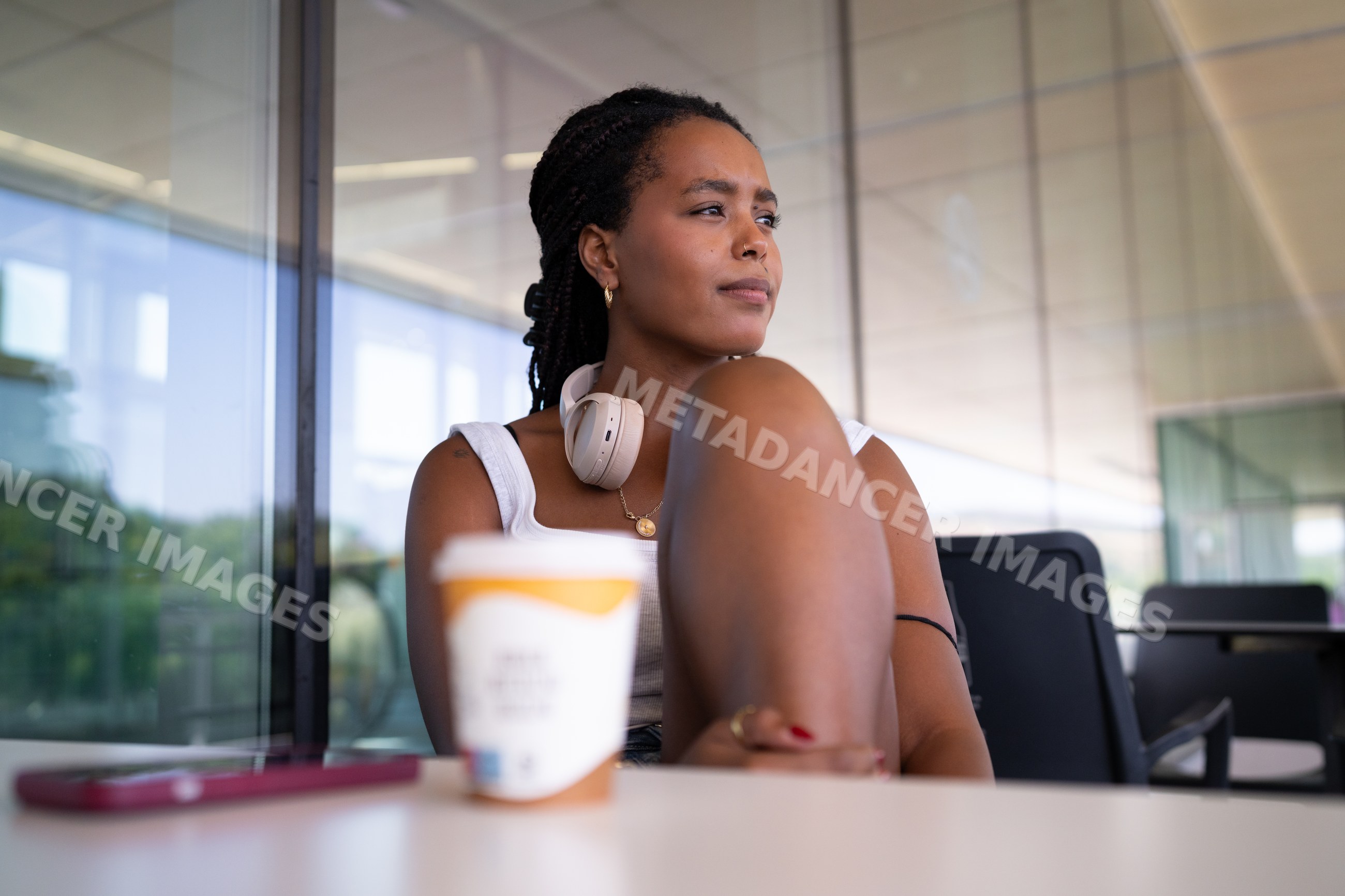 A young African American woman relaxed and thoughtful