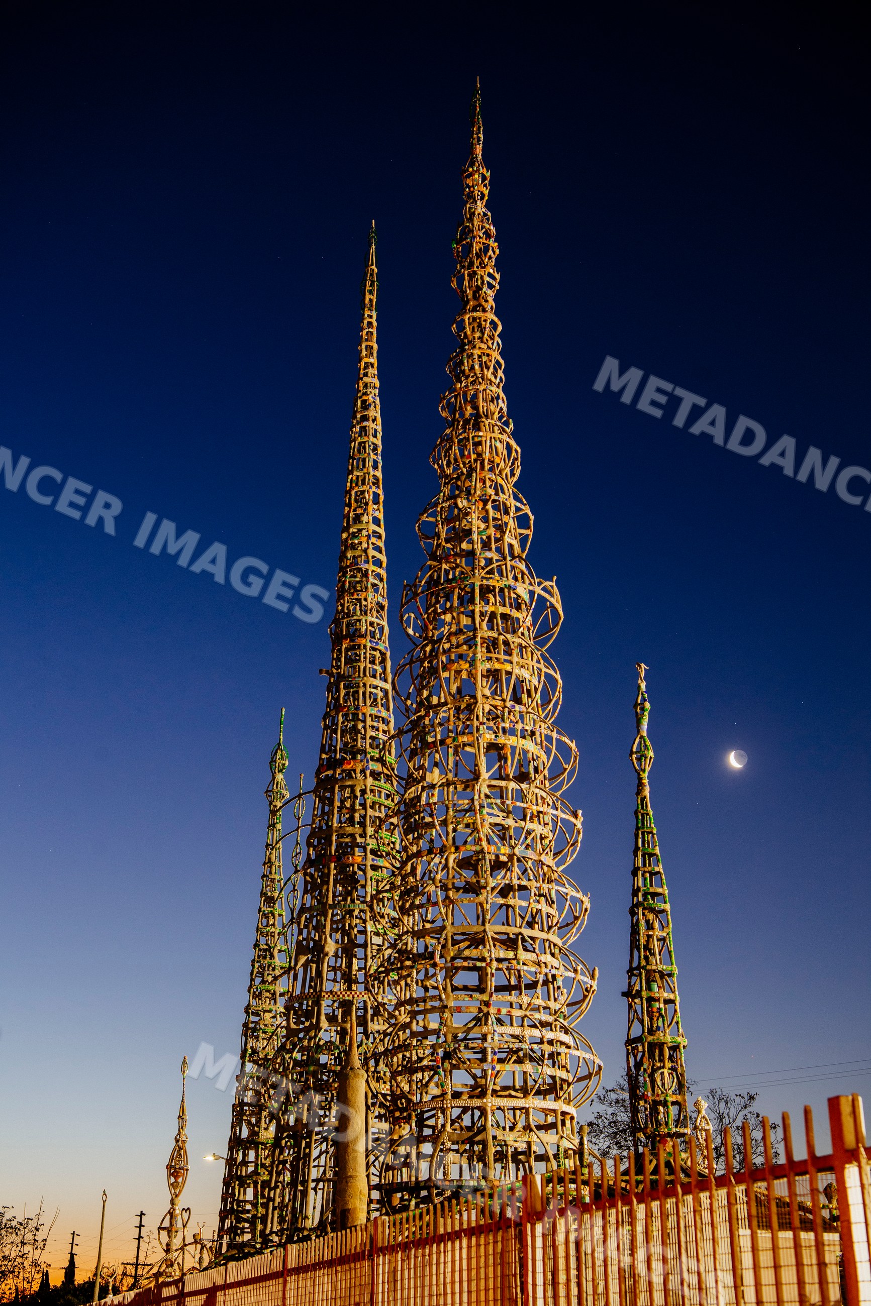 Watts towers sculpture illuminated at twilight in California