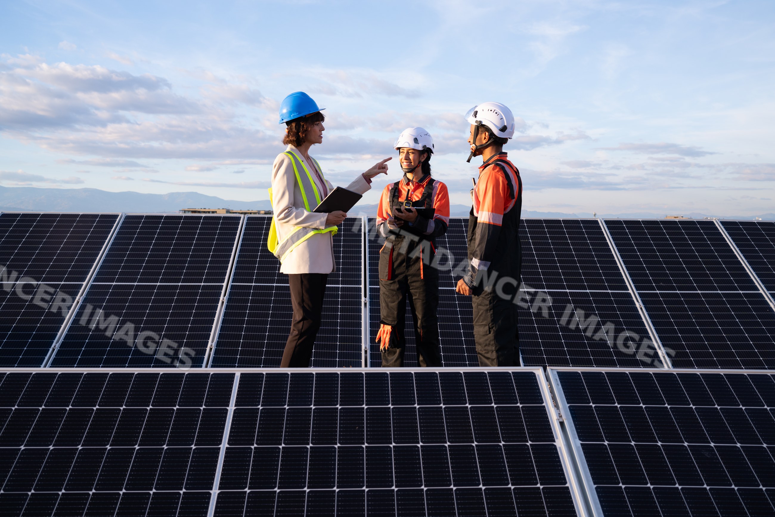 Solar energy Hispanic and white professionals inspecting solar panel