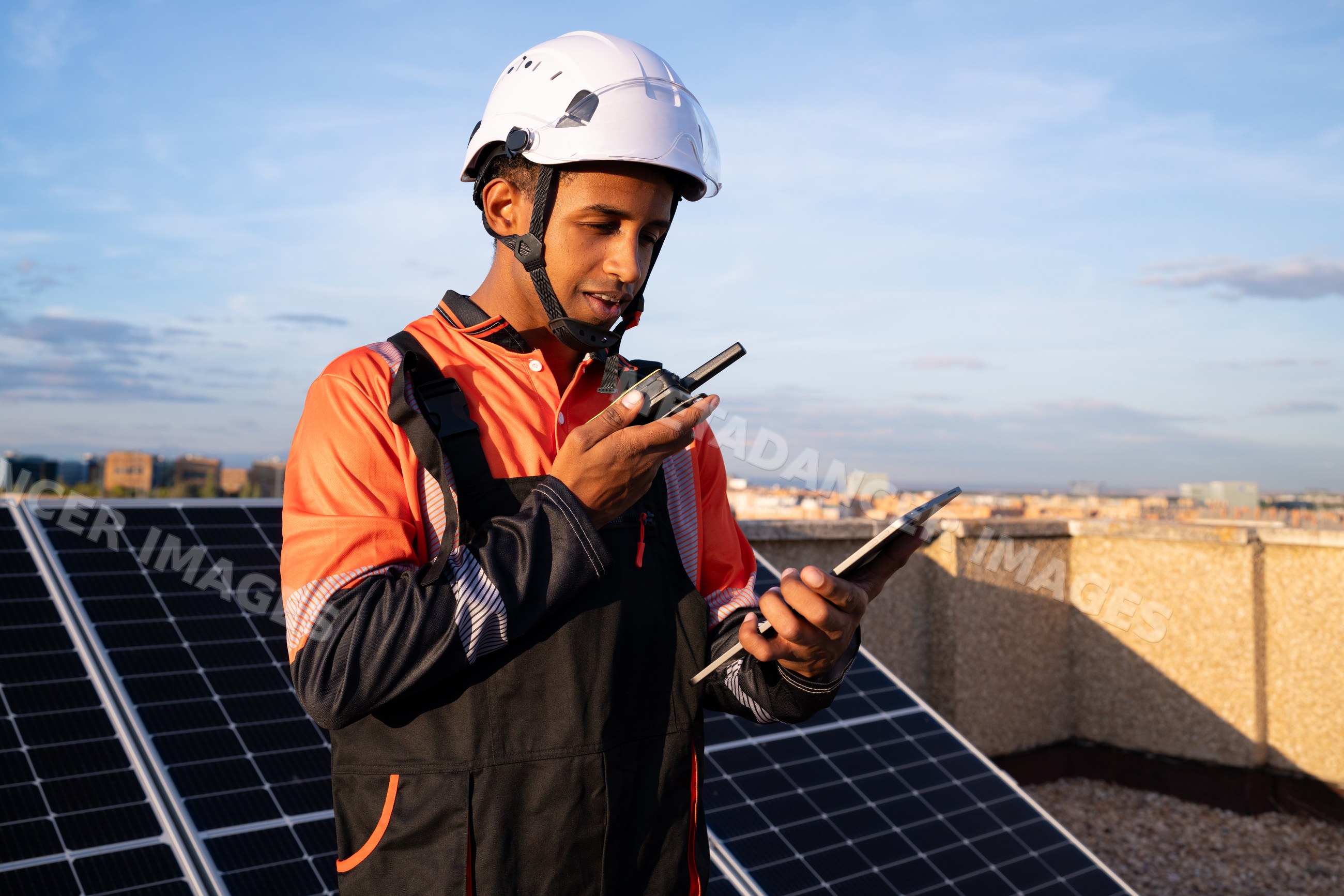 Worker inspecting solar panels on a rooftop