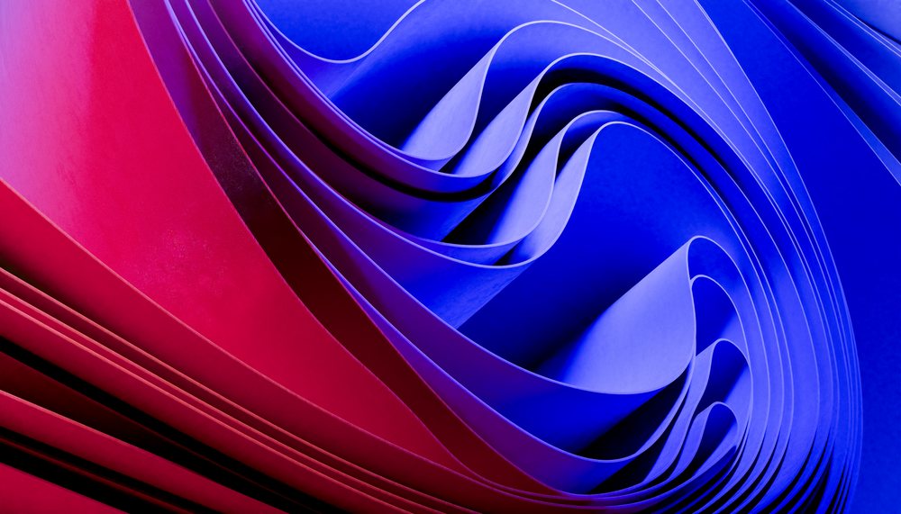 Abstract folded paper sculpture with red and blue waves