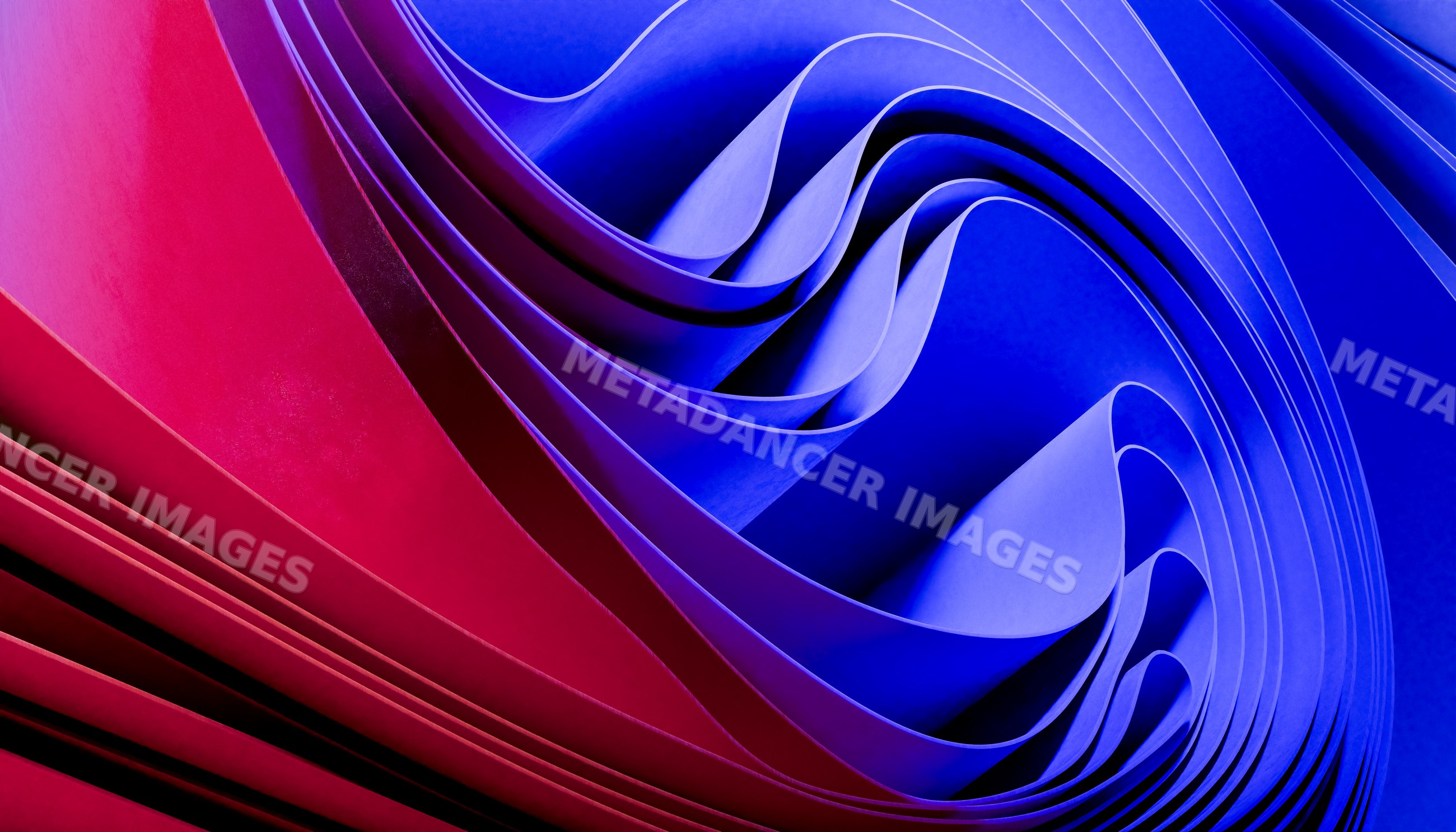 Abstract folded paper sculpture with red and blue waves