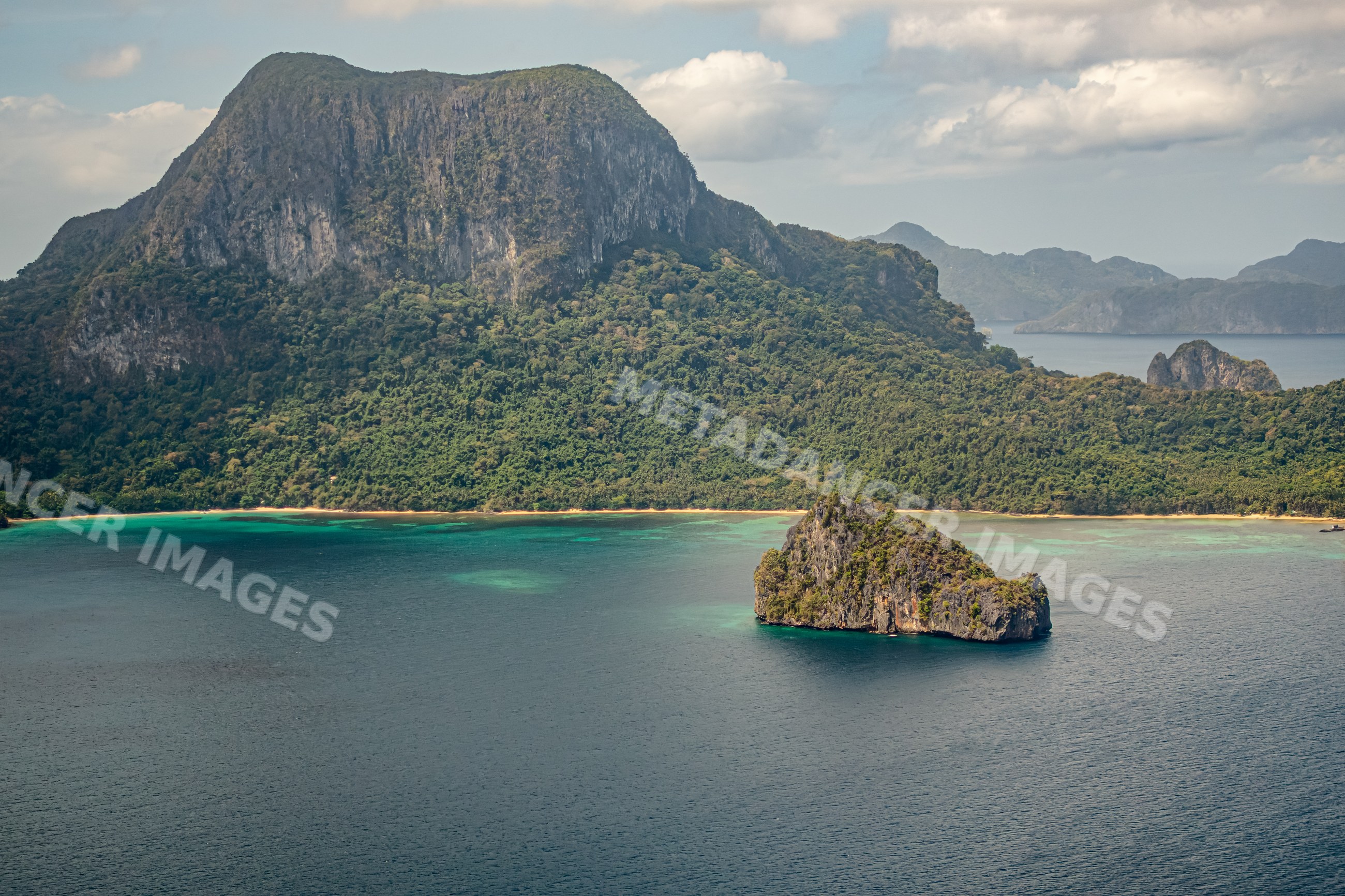 Island with rocky formation and tropical greenery