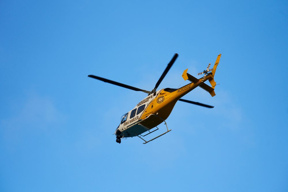 Fire rescue helicopter flying in blue sky