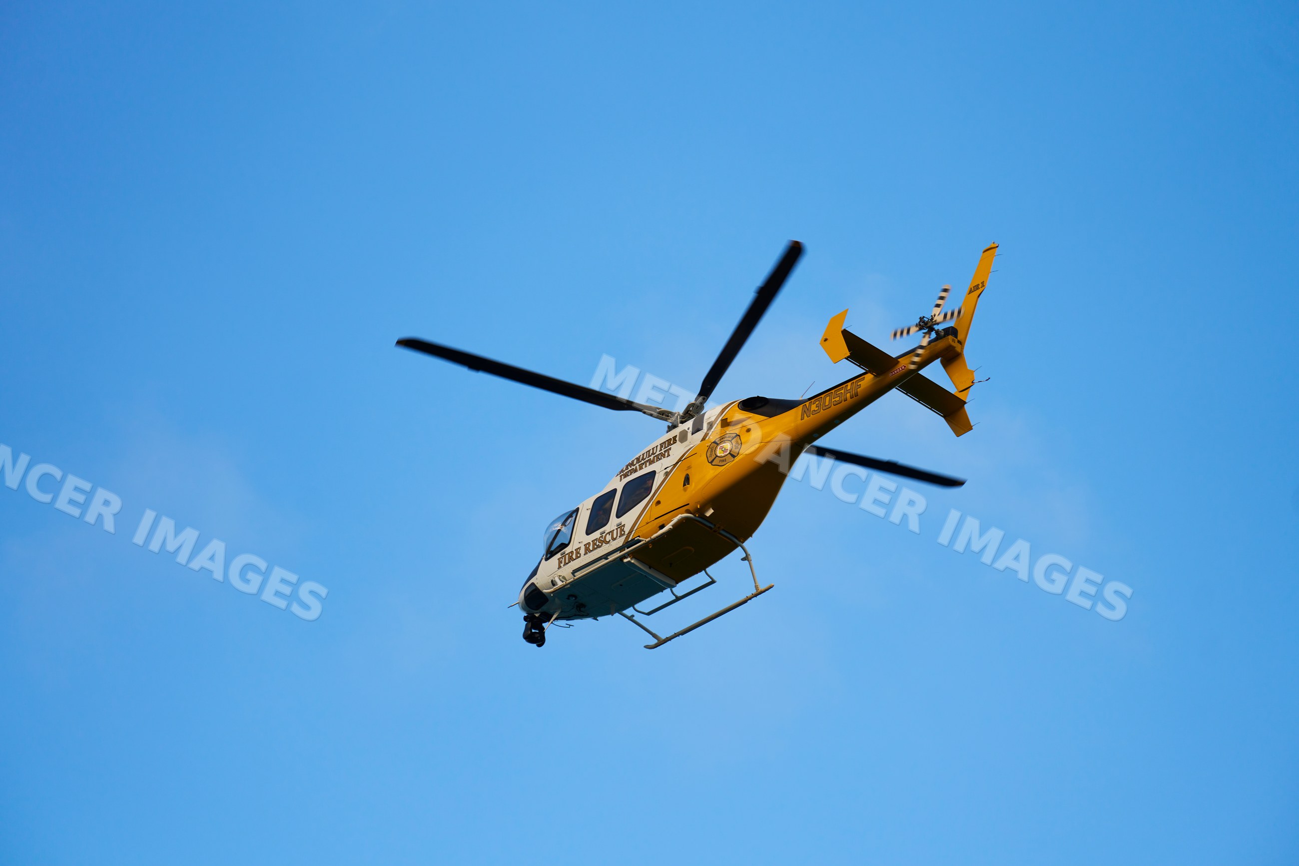 Fire rescue helicopter flying in blue sky