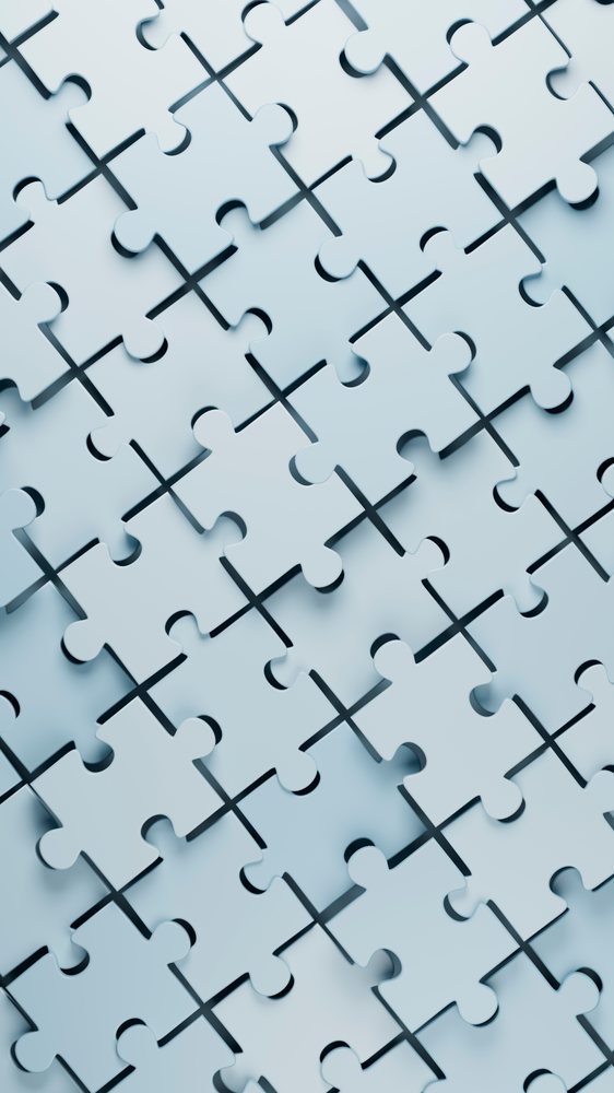 Interlocking white puzzle pieces forming a connected surface
