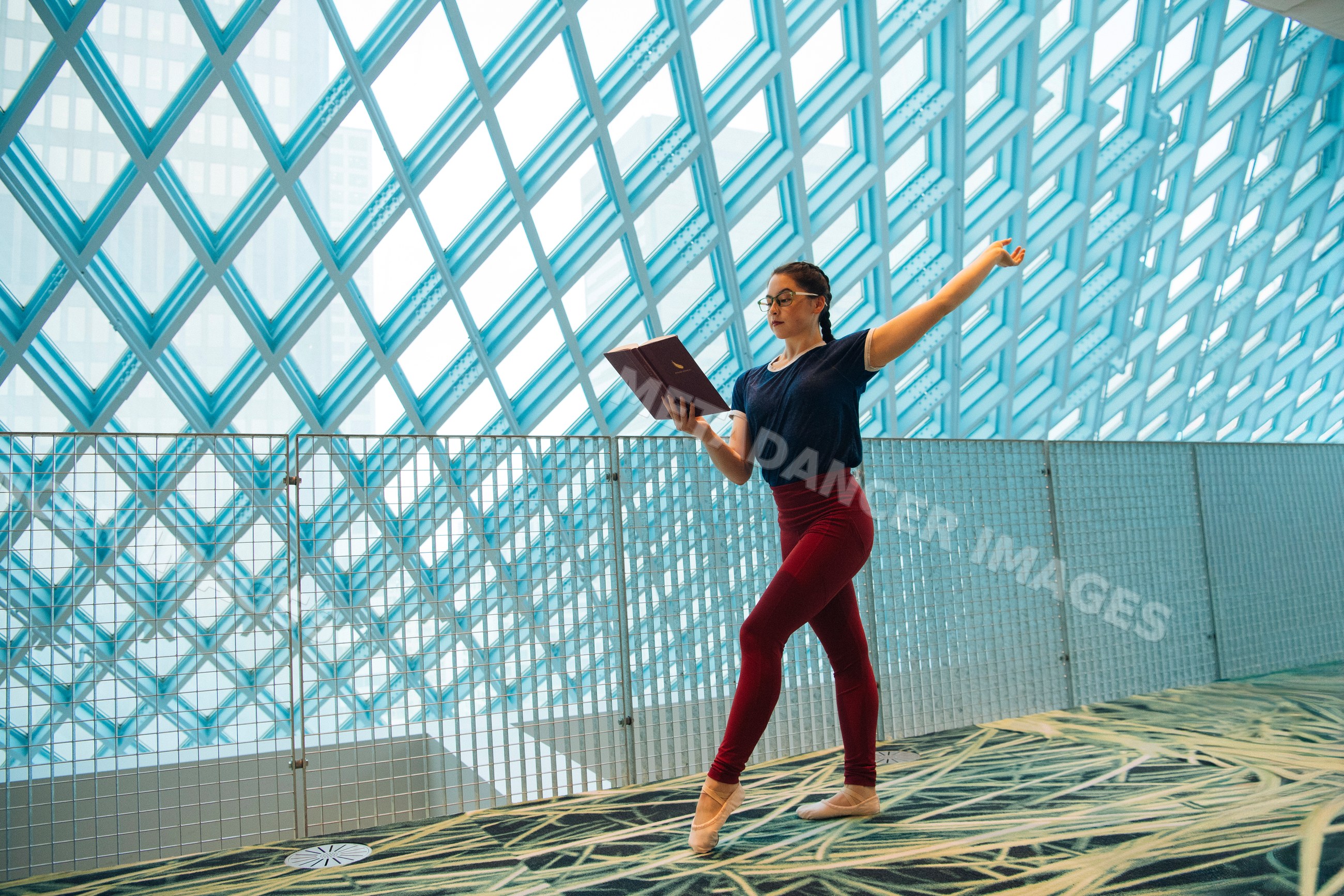 Woman practicing ballet and reading a book