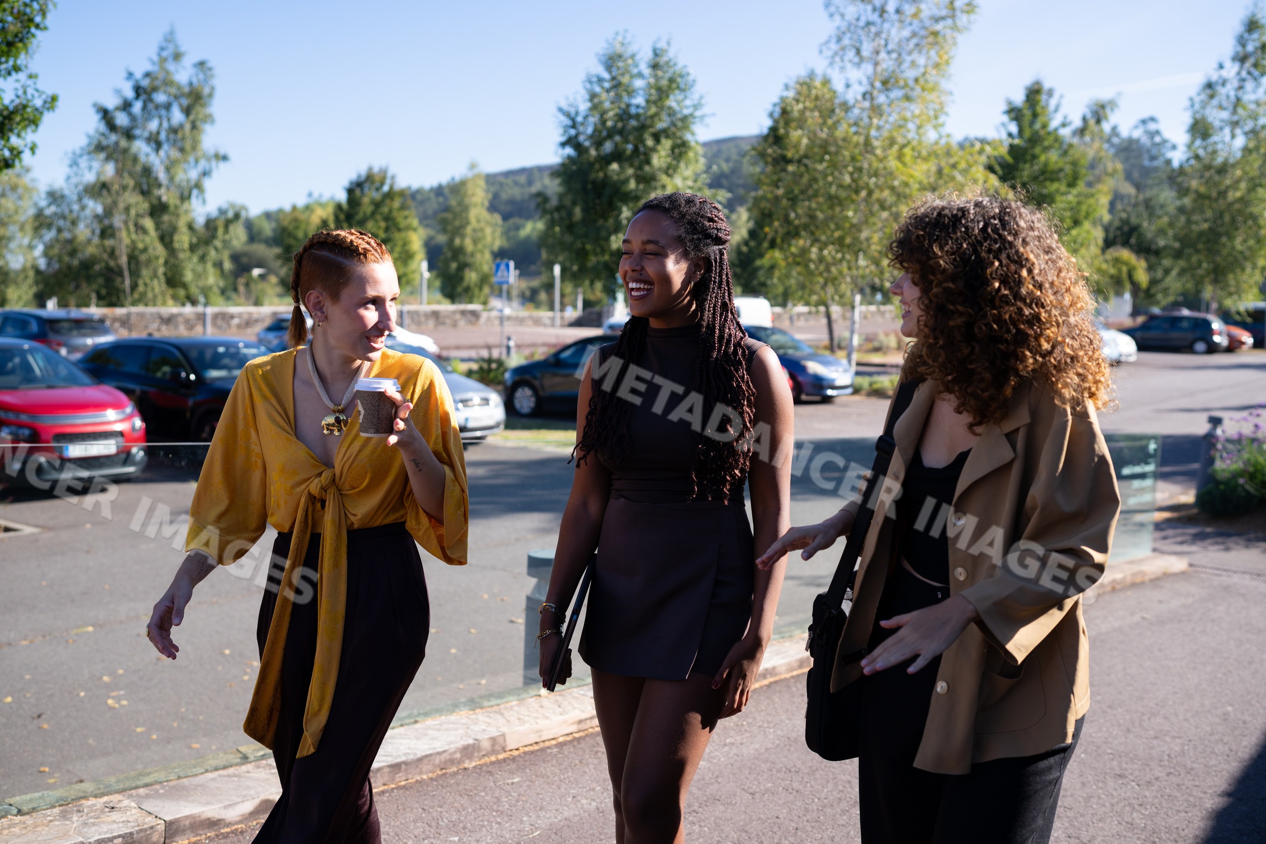 Three African American and white women walking and chatting