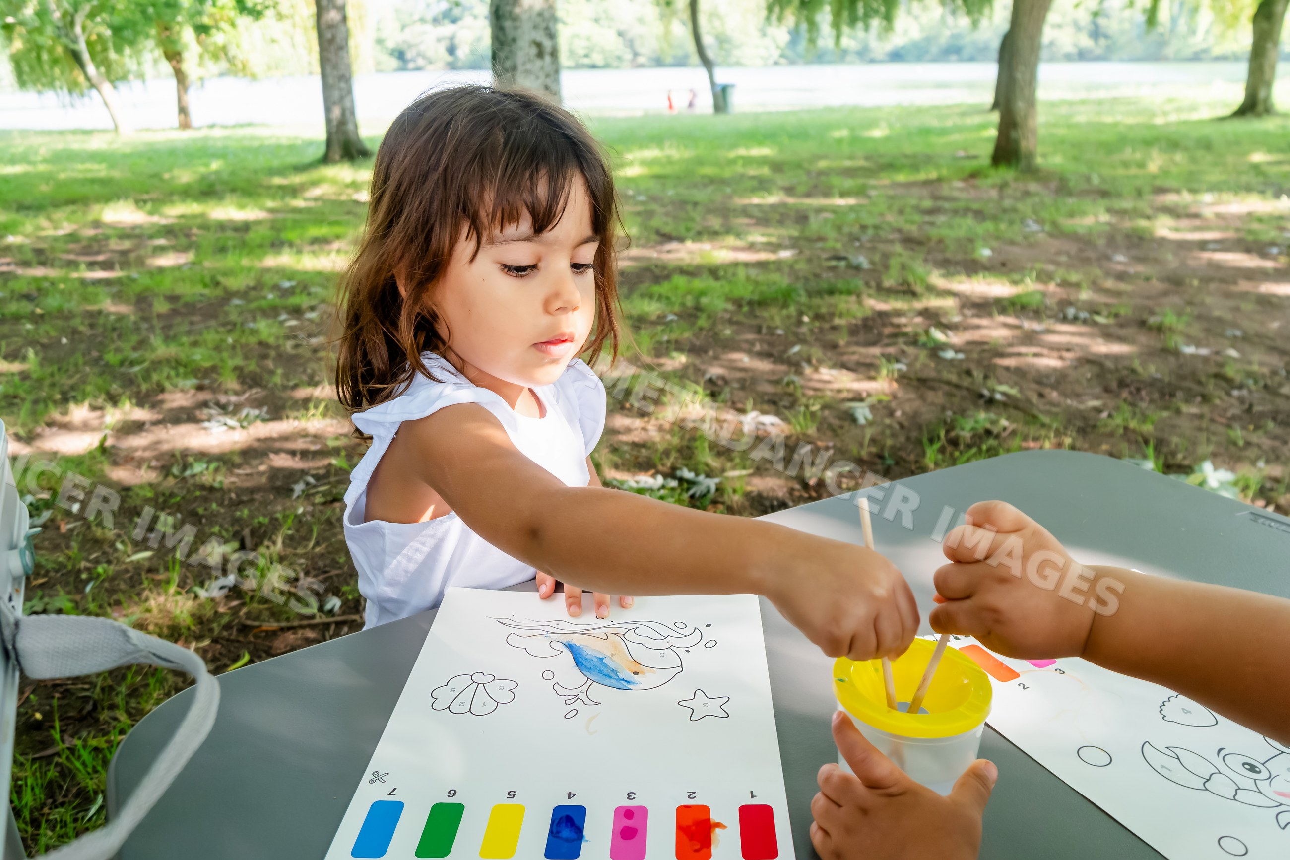 White child painting bird coloring page outdoors