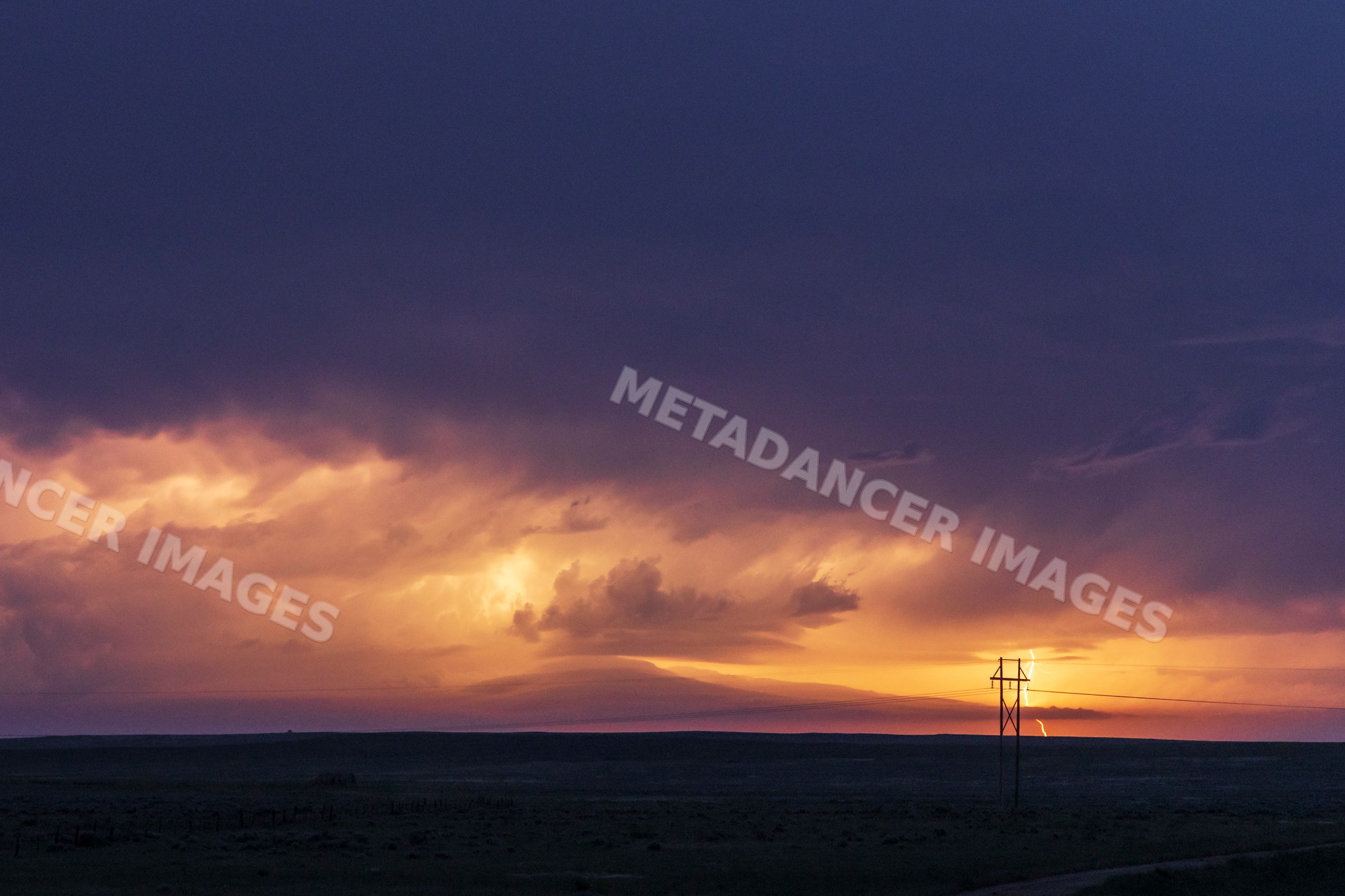 Shelf Cloud and lightning strike at sunset over montana plains