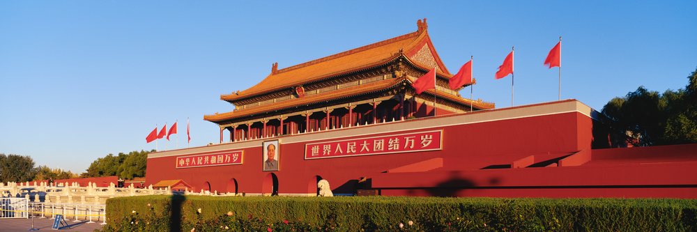 Tiananmen gate with flags and portrait