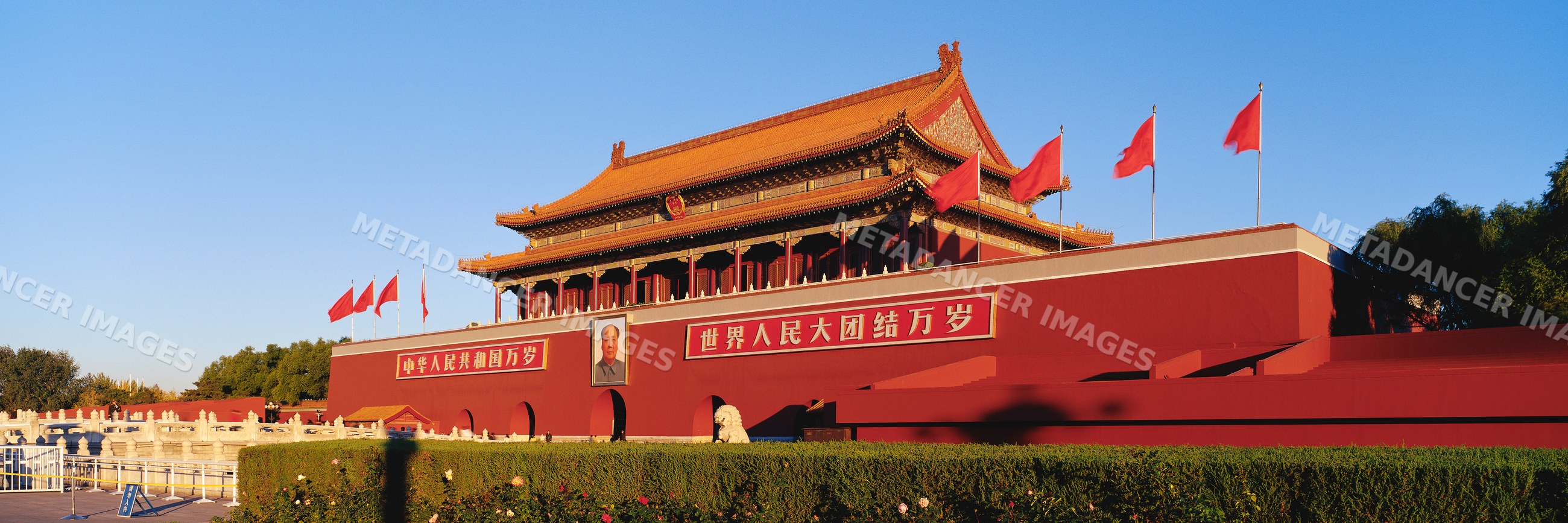 Tiananmen gate with flags and portrait