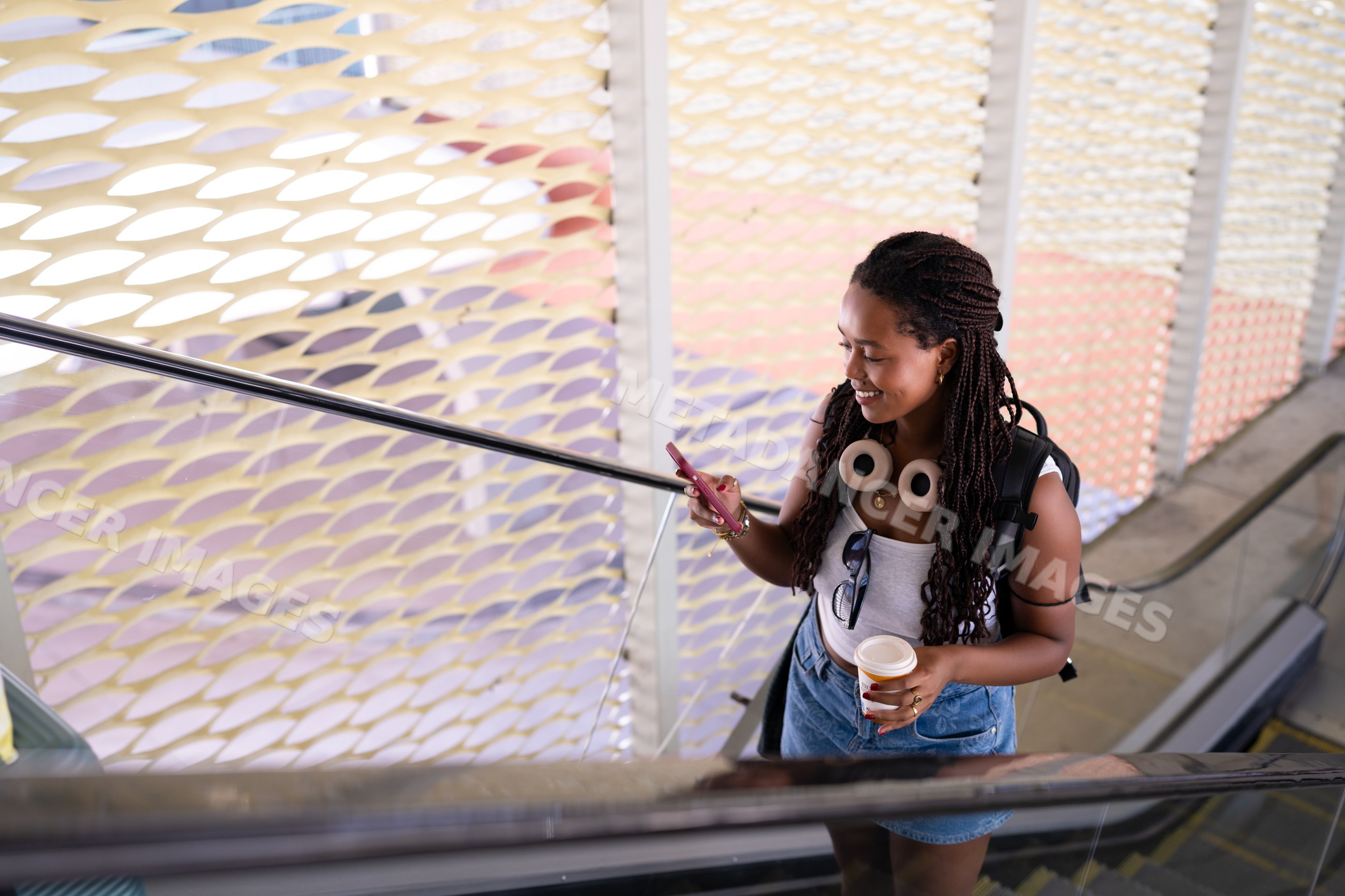A young African American woman uses her smartphone