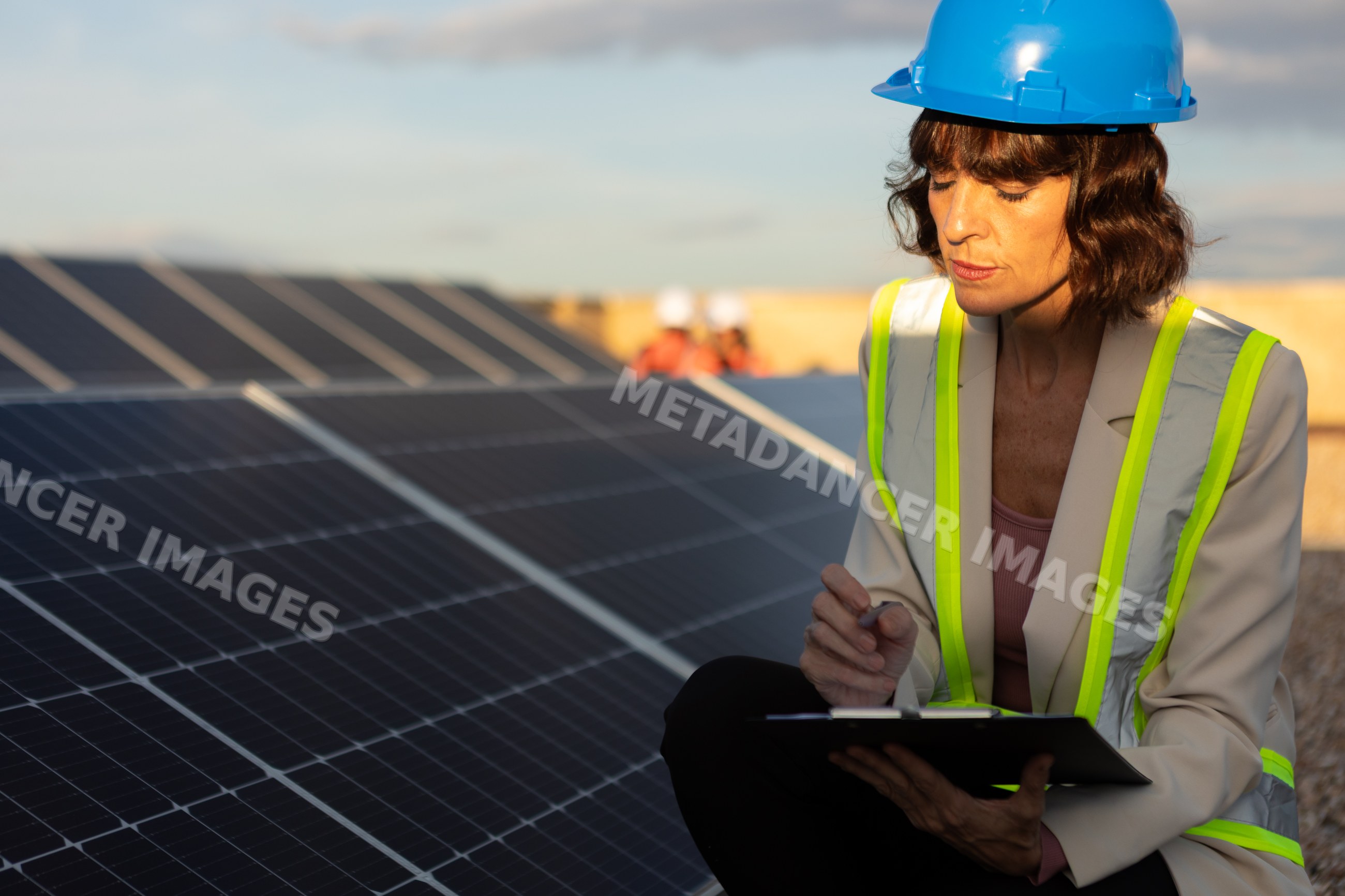 Solar energy expert inspecting solar panels outdoors in Madrid, Spain