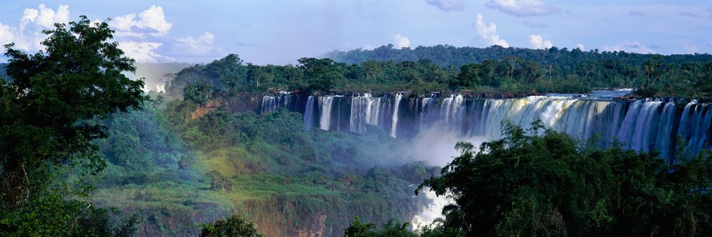 Iguacu falls cascading over cliffs in rainforest in misiones