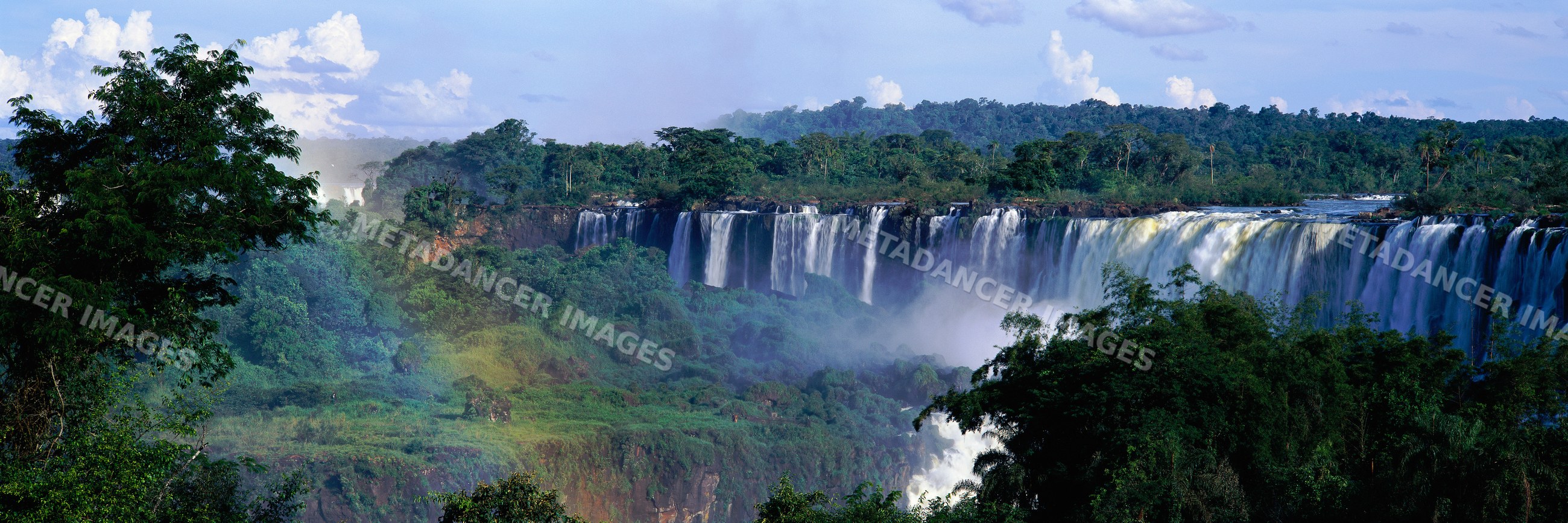 Iguacu falls cascading over cliffs in rainforest in misiones