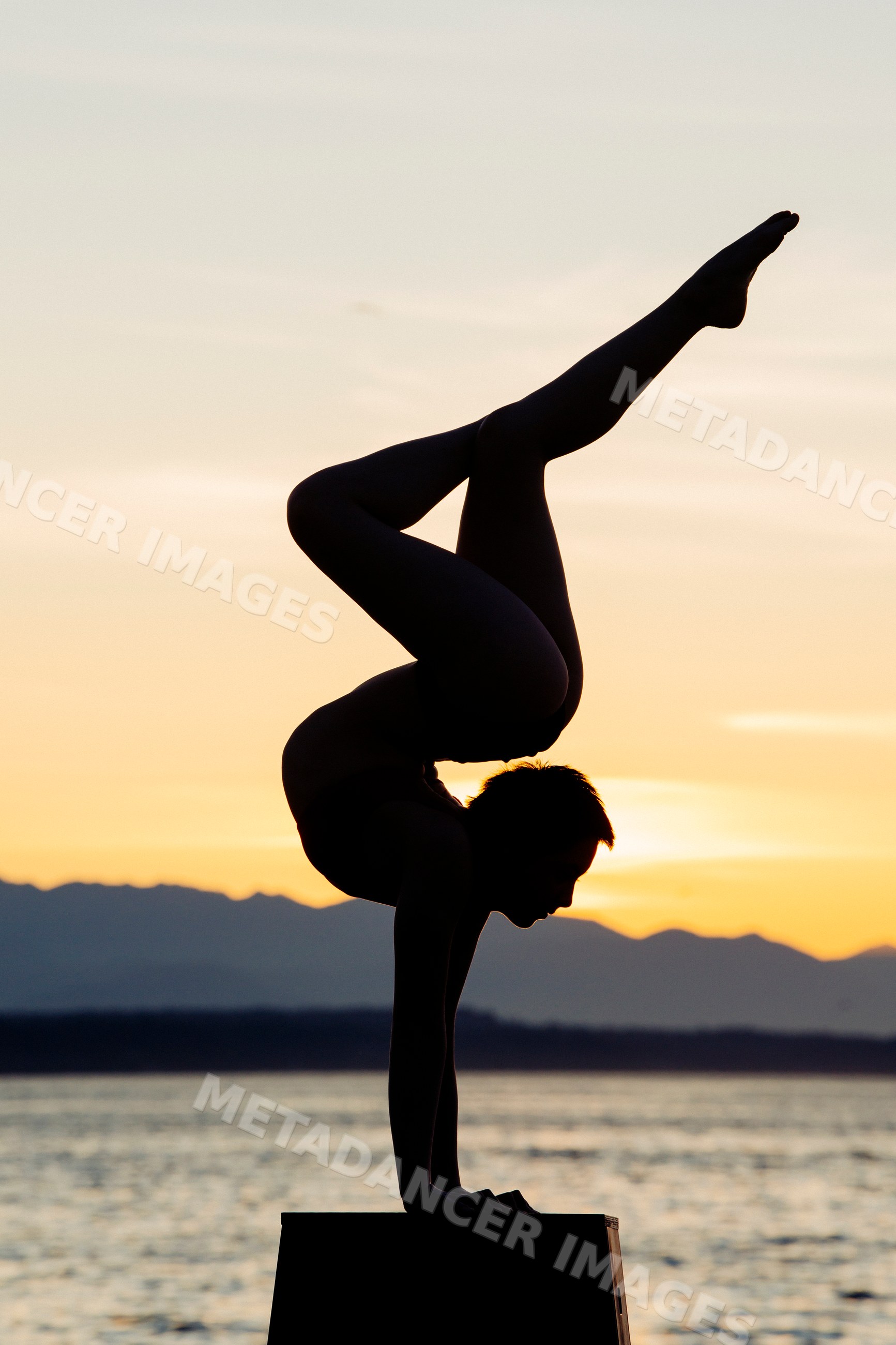White person doing handstand yoga pose