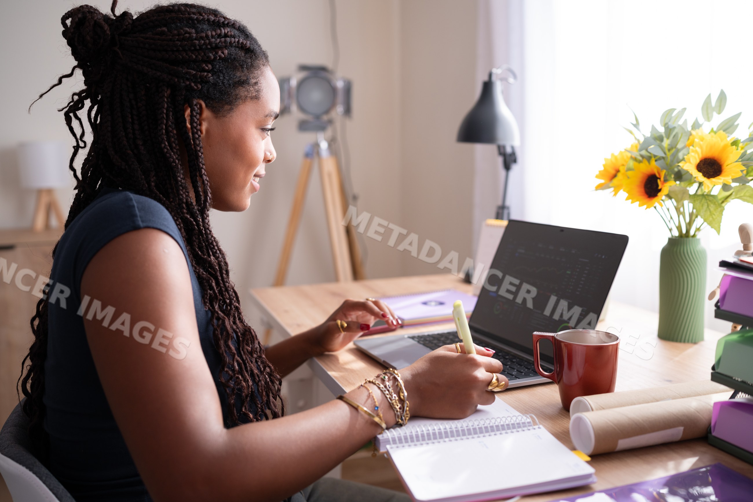 African American woman writing in a notebook