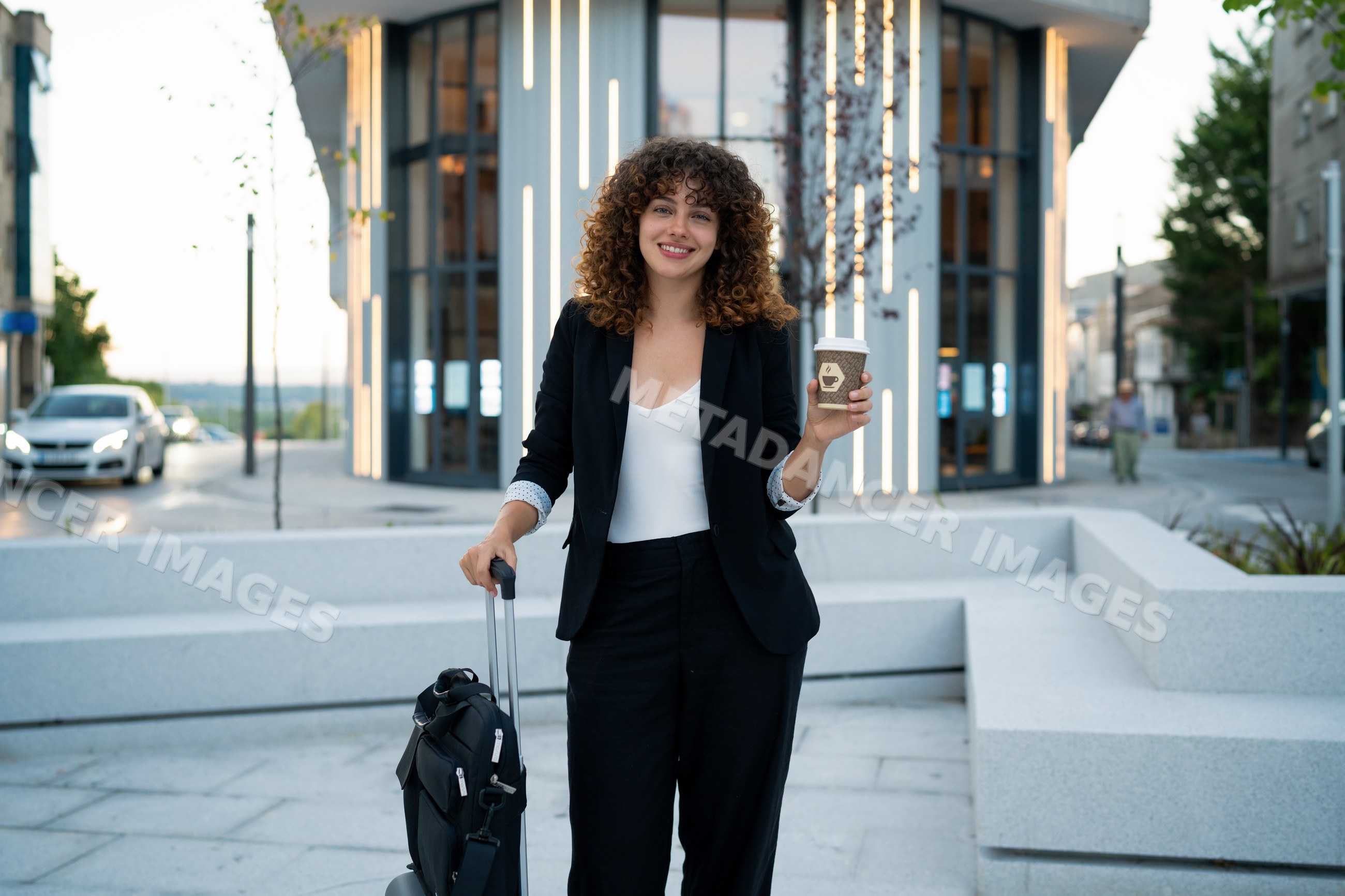Business white woman holding coffee cup with luggage