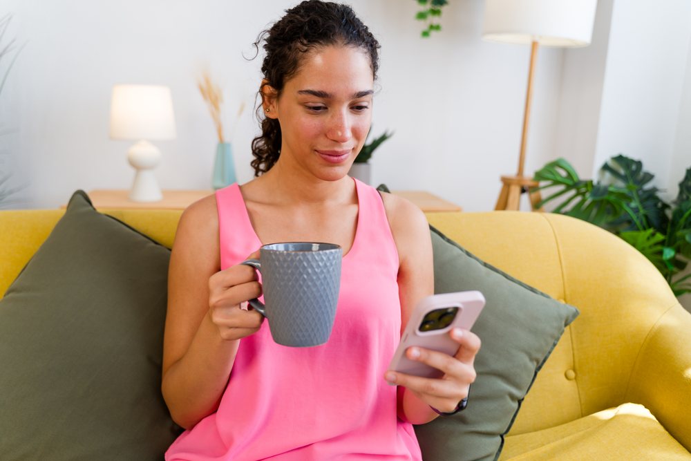 A young Hispanic woman relaxes with coffee