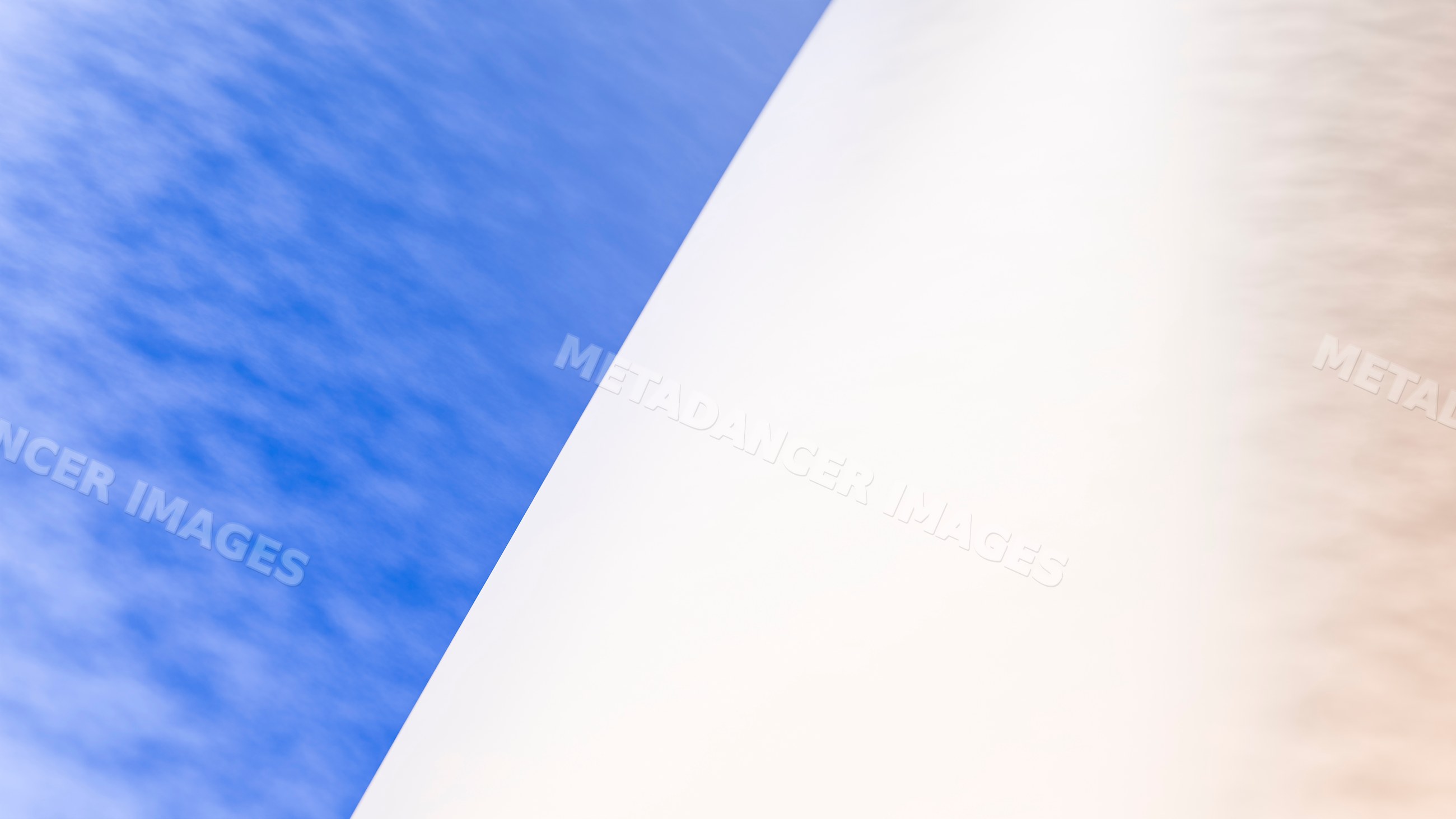 White curved architectural structure against bright blue sky