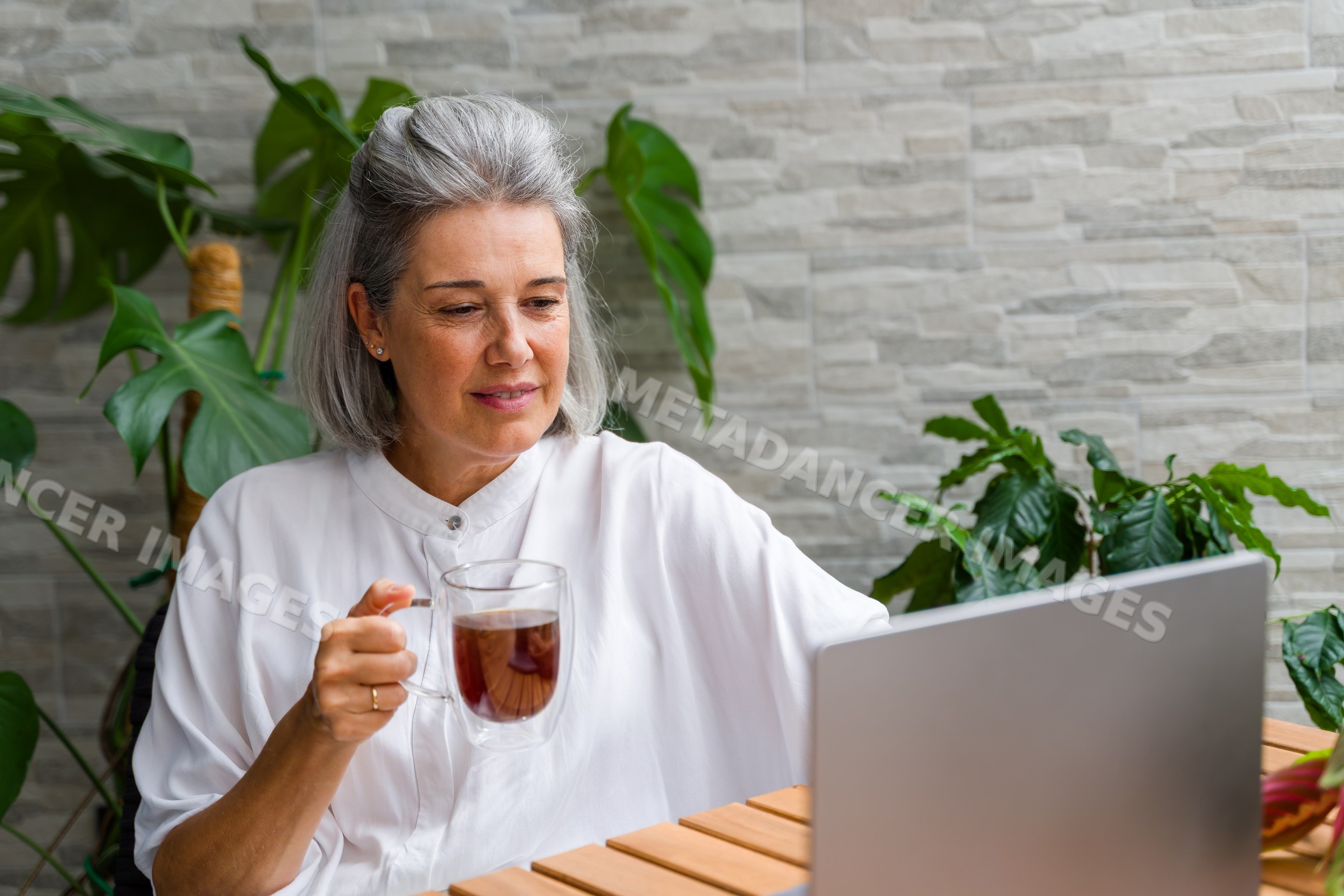 Mature white woman drinking tea