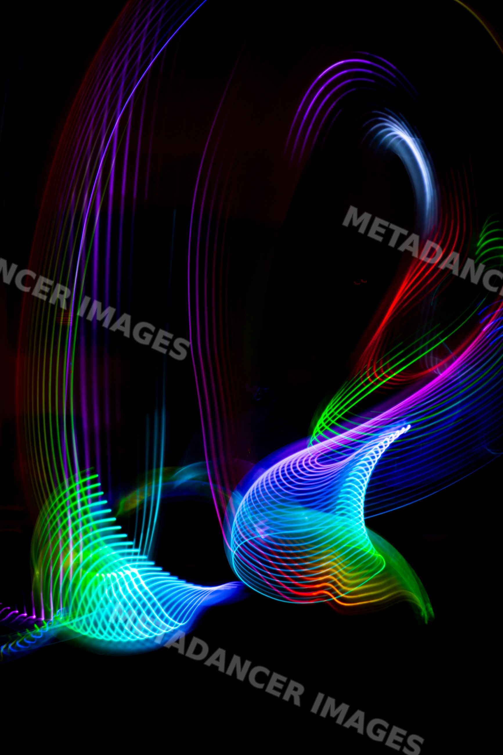 Colorful led light painting with swirling patterns on black background