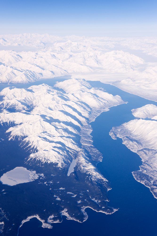 Aerial view of snow-covered mountains and fjords