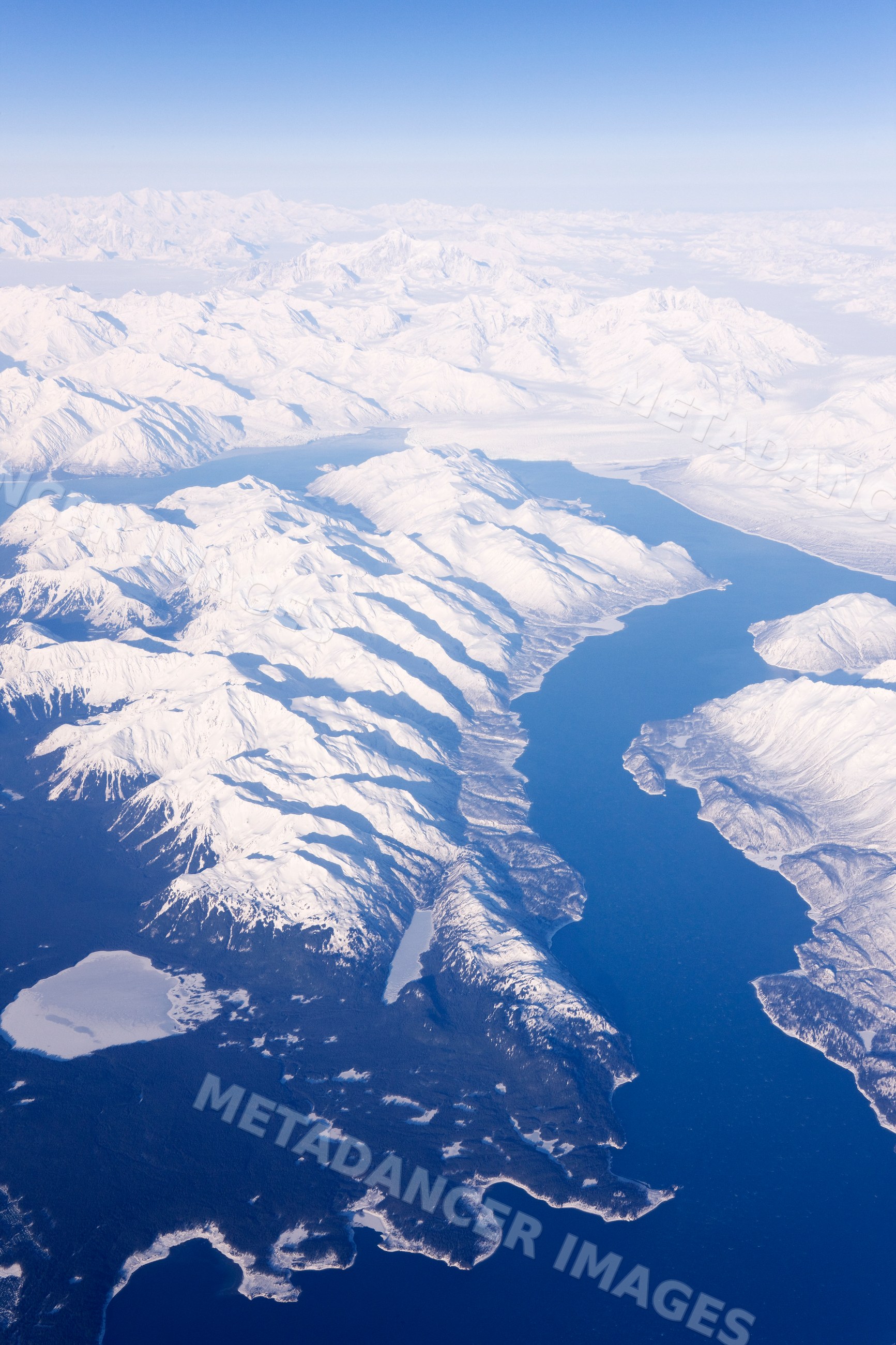 Aerial view of snow-covered mountains and fjords