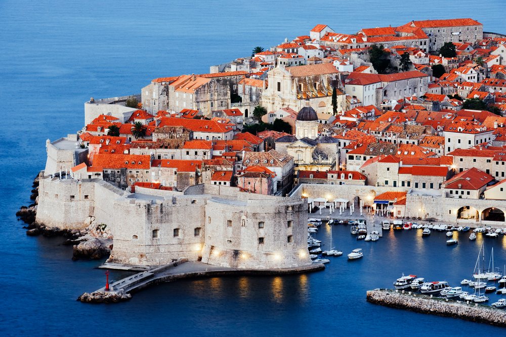 Old city of dubrovnik at dawn with harbor and castle walls
