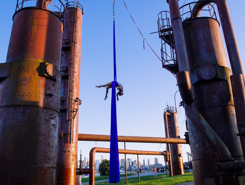 Aerial silk performance in Seattle with city skyline