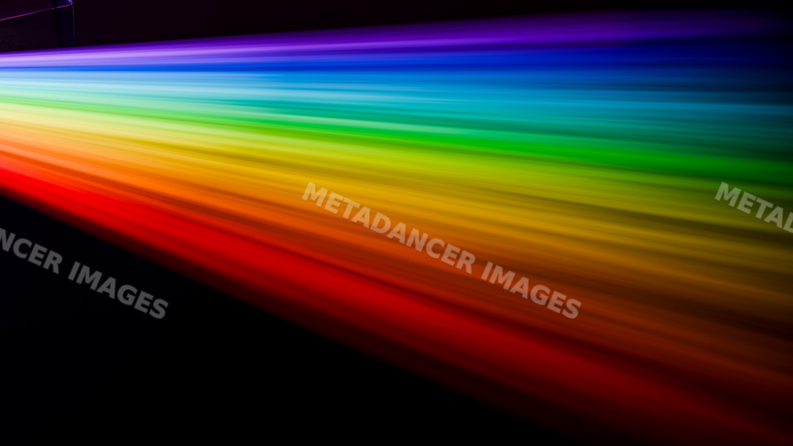 Rainbow light spectrum beam with vibrant colors on black background