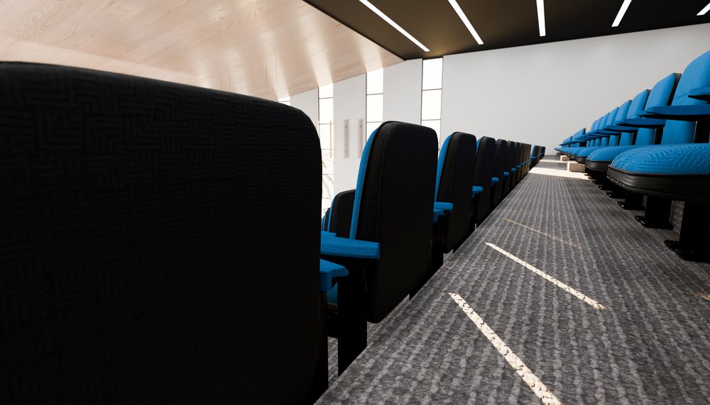 Modern lecture hall with blue cushioned seats and black backs