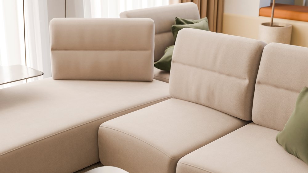 Beige sectional sofa with green pillows in modern living room