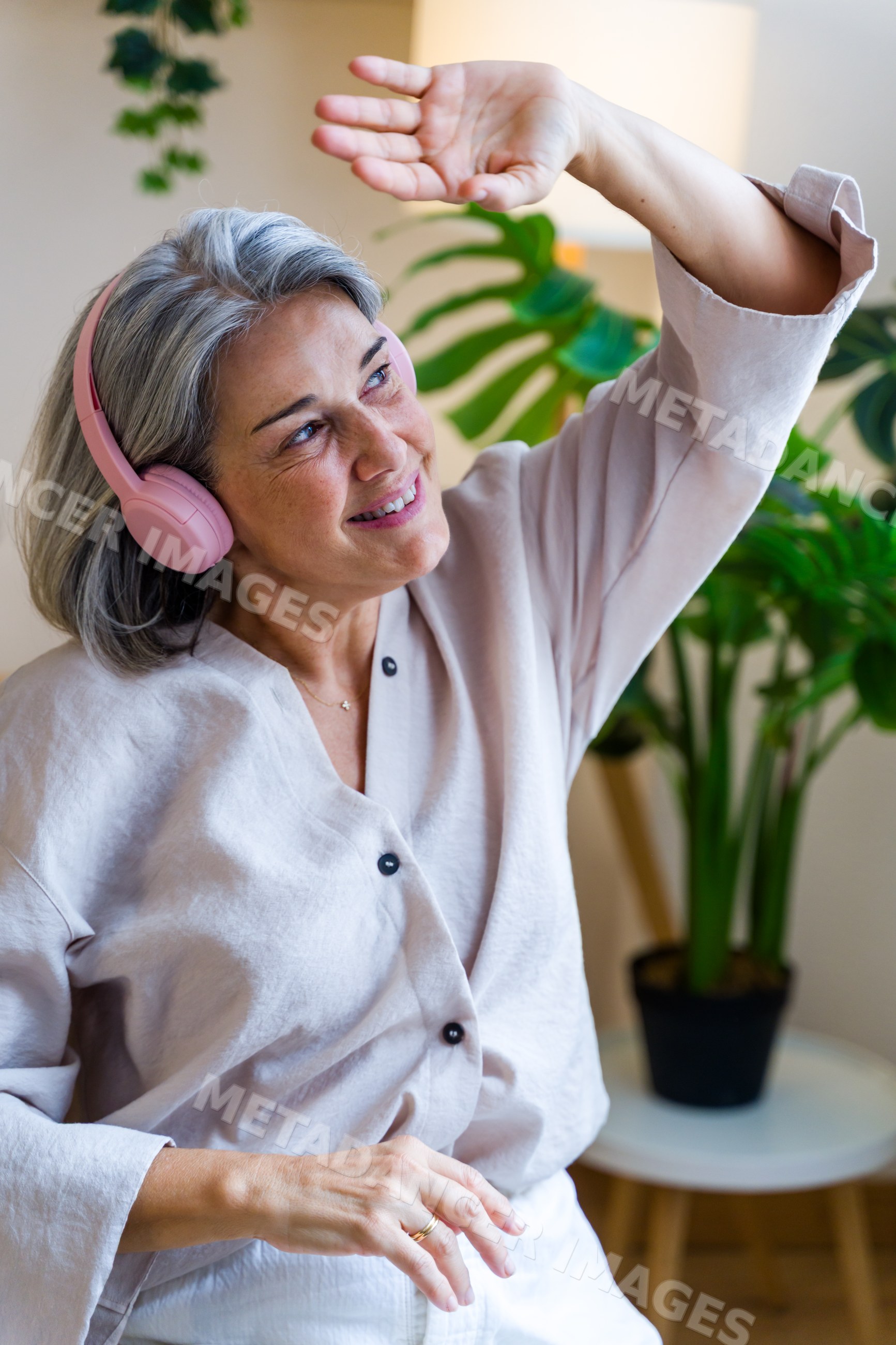 Middle-aged white woman enjoying music and dancing indoors