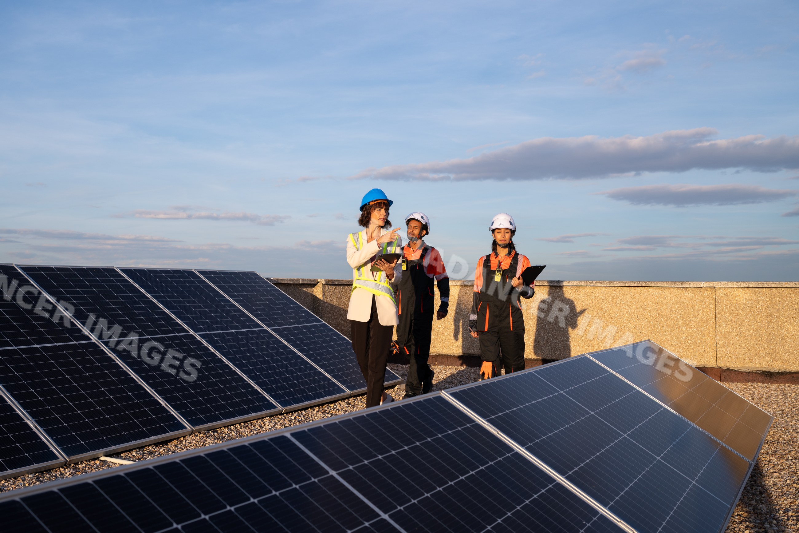 Engineers inspecting rooftop solar panels installation in Madrid