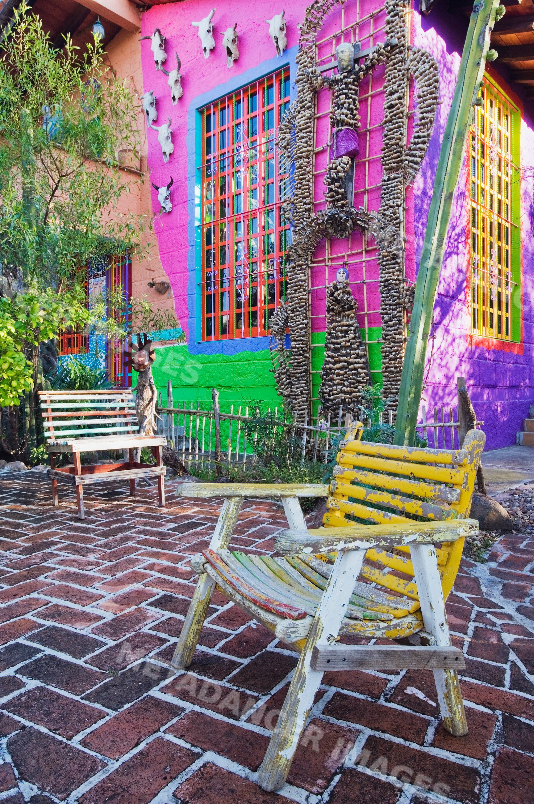 Wooden chairs outside vibrant house mexico