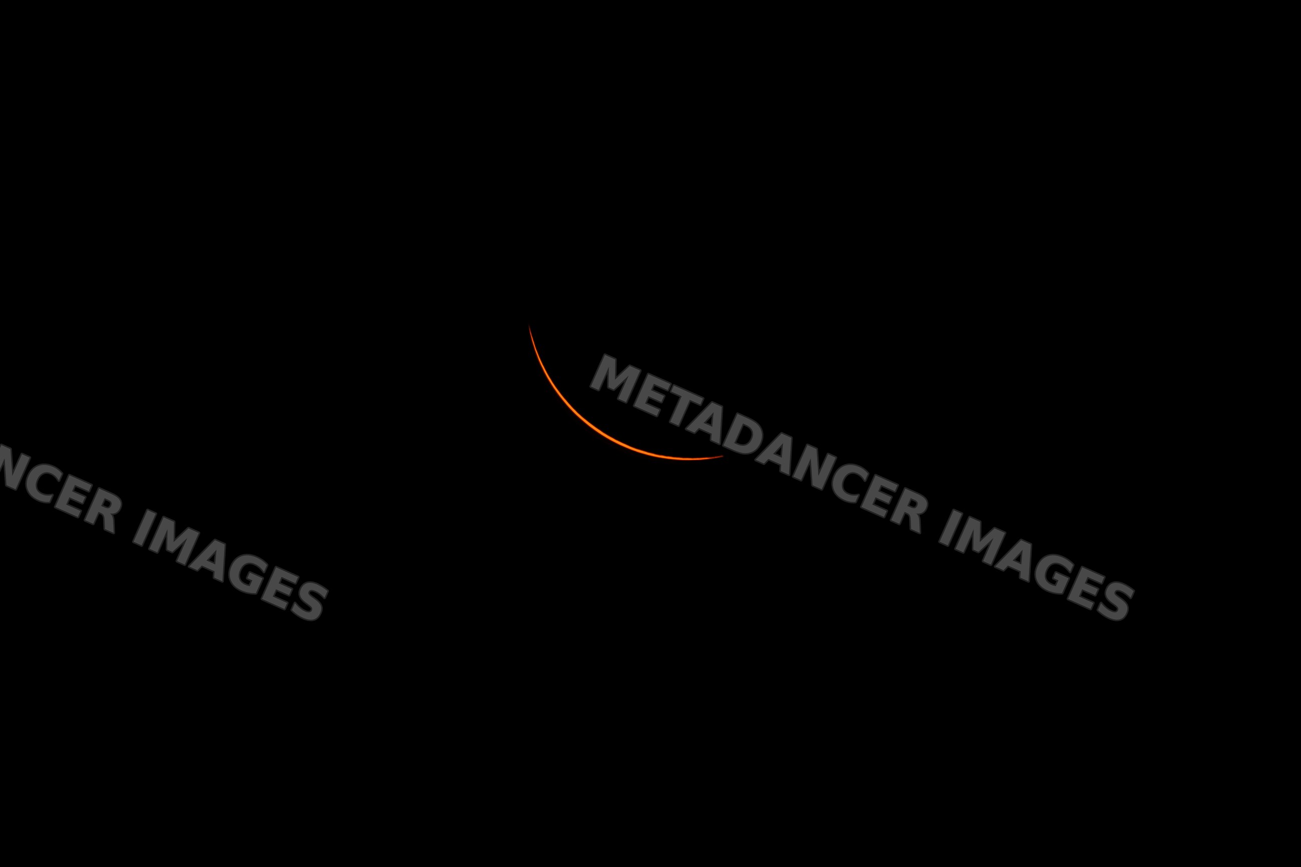 Solar eclipse showing crescent sun in dark sky