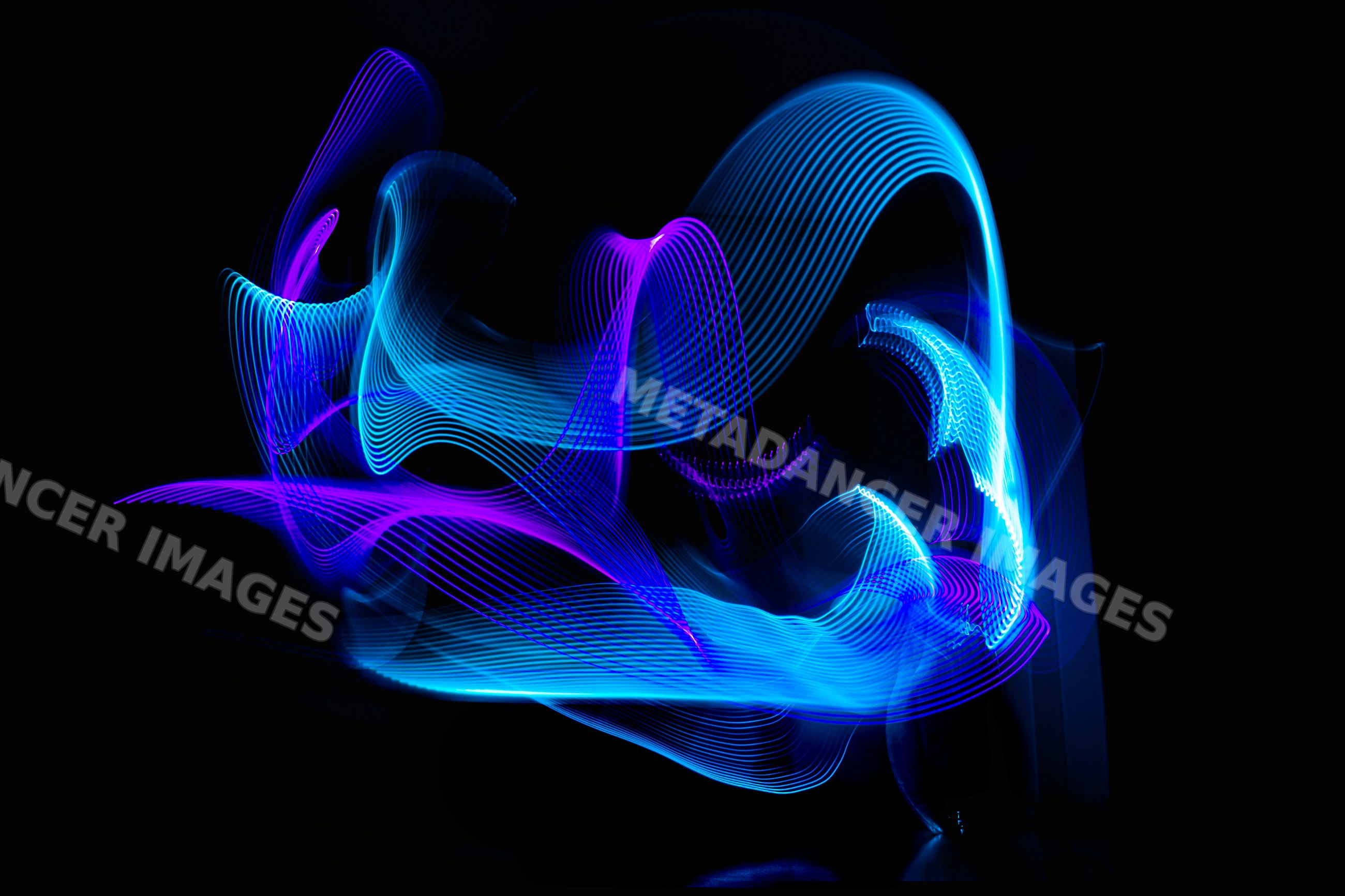 Light painting with blue and purple LED ribbons on dark background