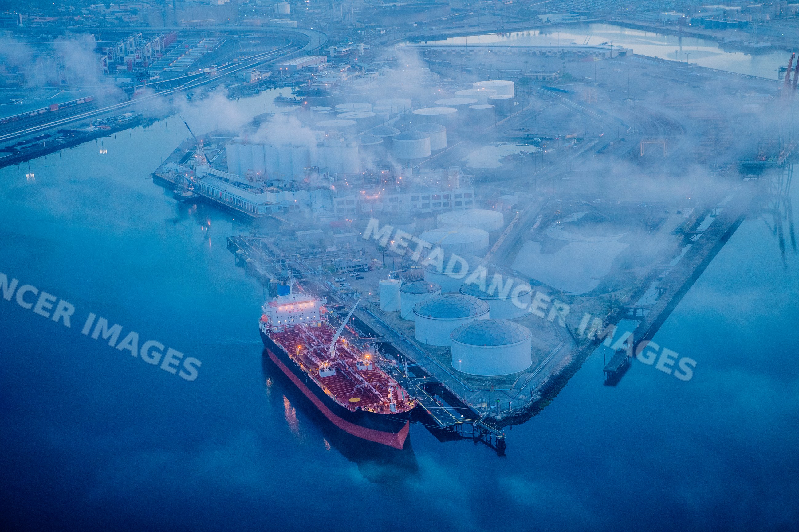 Oil tanker docked at fuel storage terminal in a beach