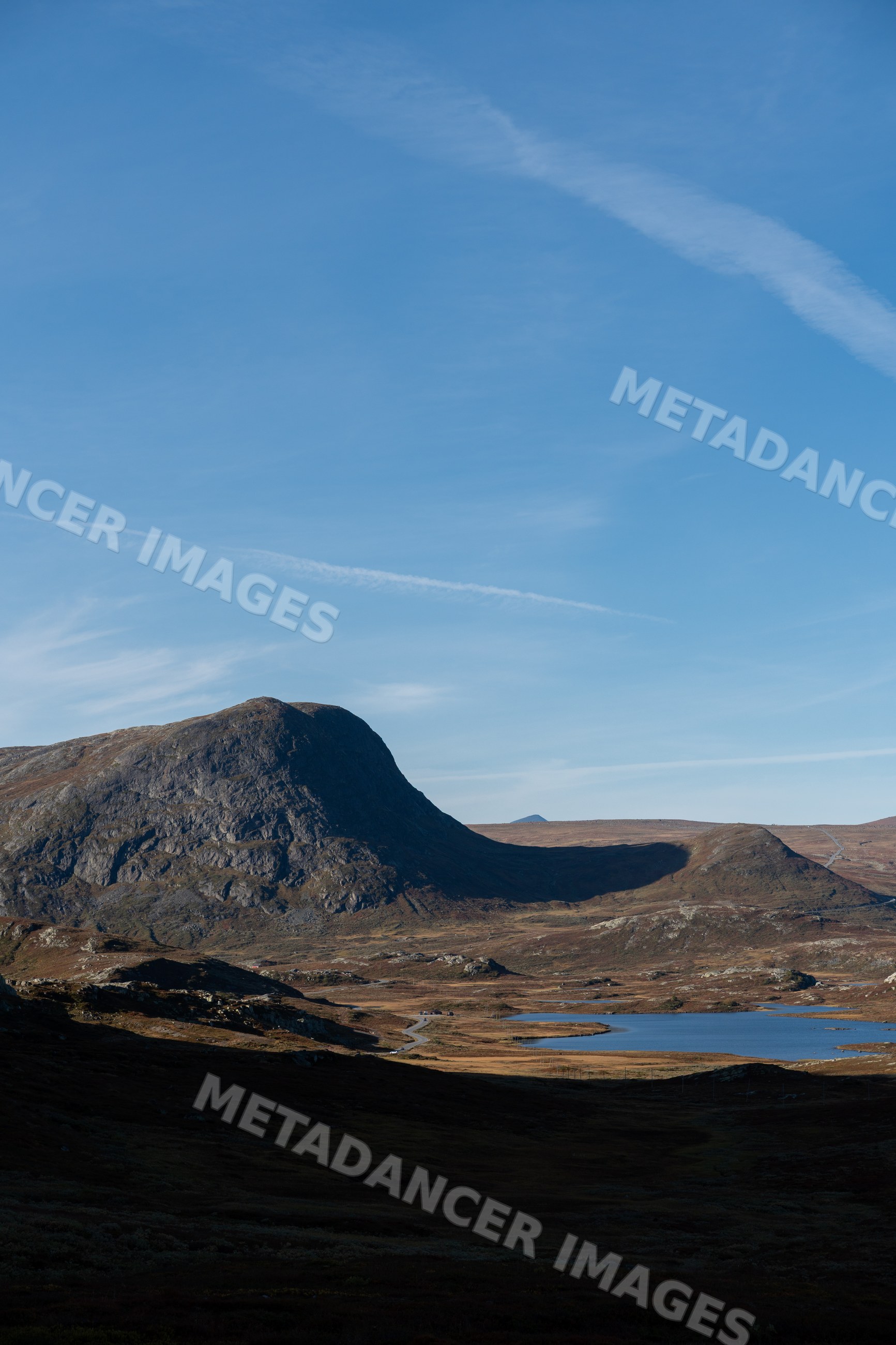 Mountain landscape with lake and winding road