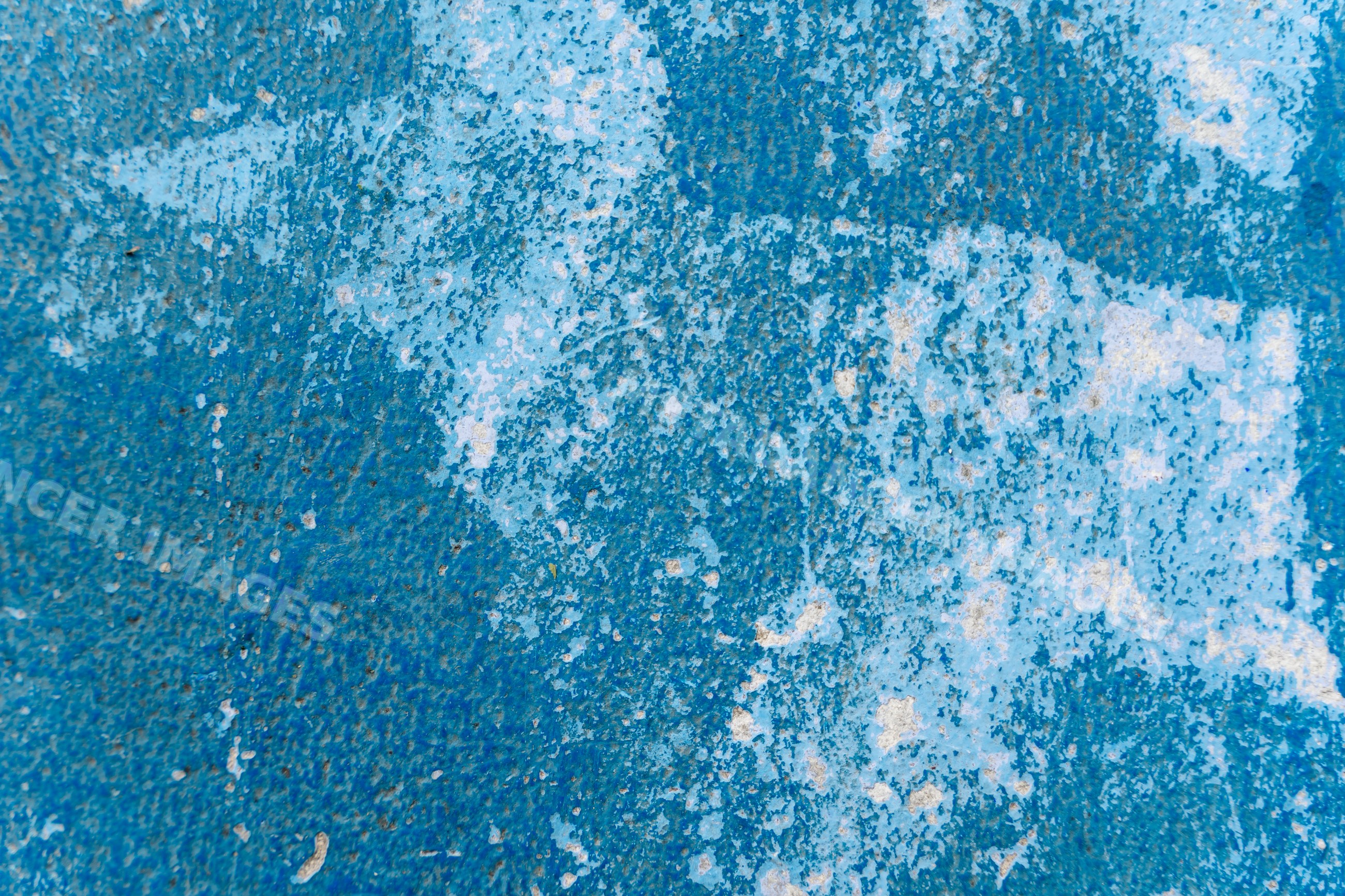 Blue abstract textured surface with peeling and weathered paint