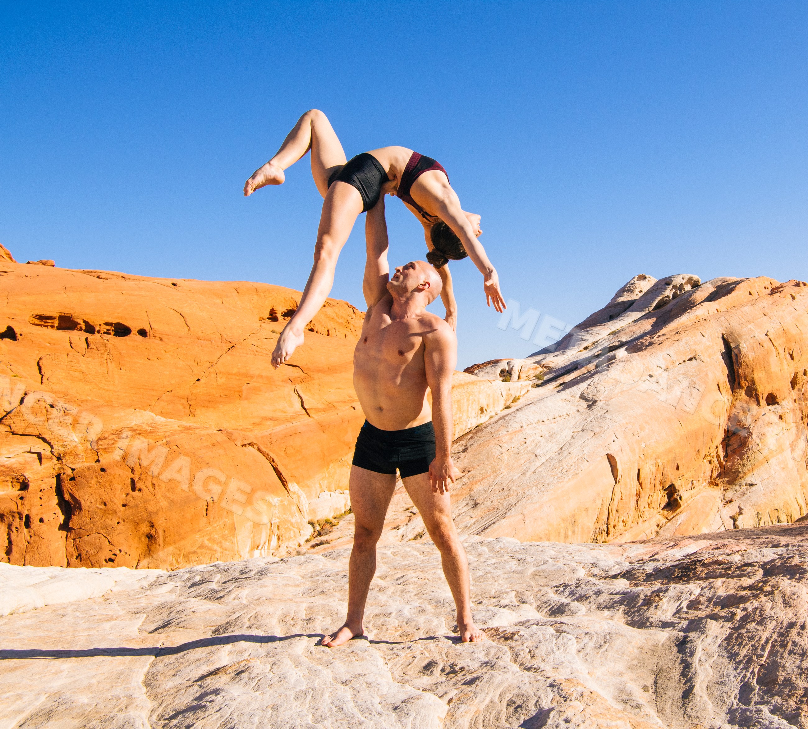 Acrobatic yoga pose on rock formations in USA desert