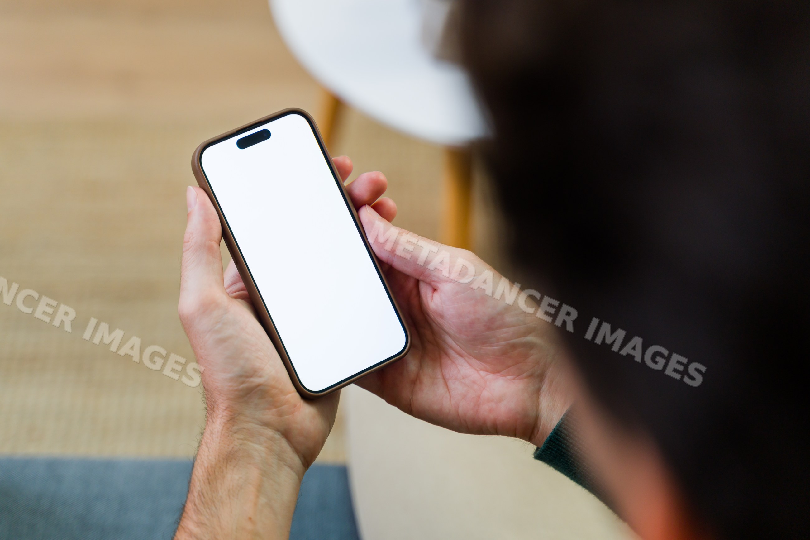Person holding smartphone with blank white screen setting