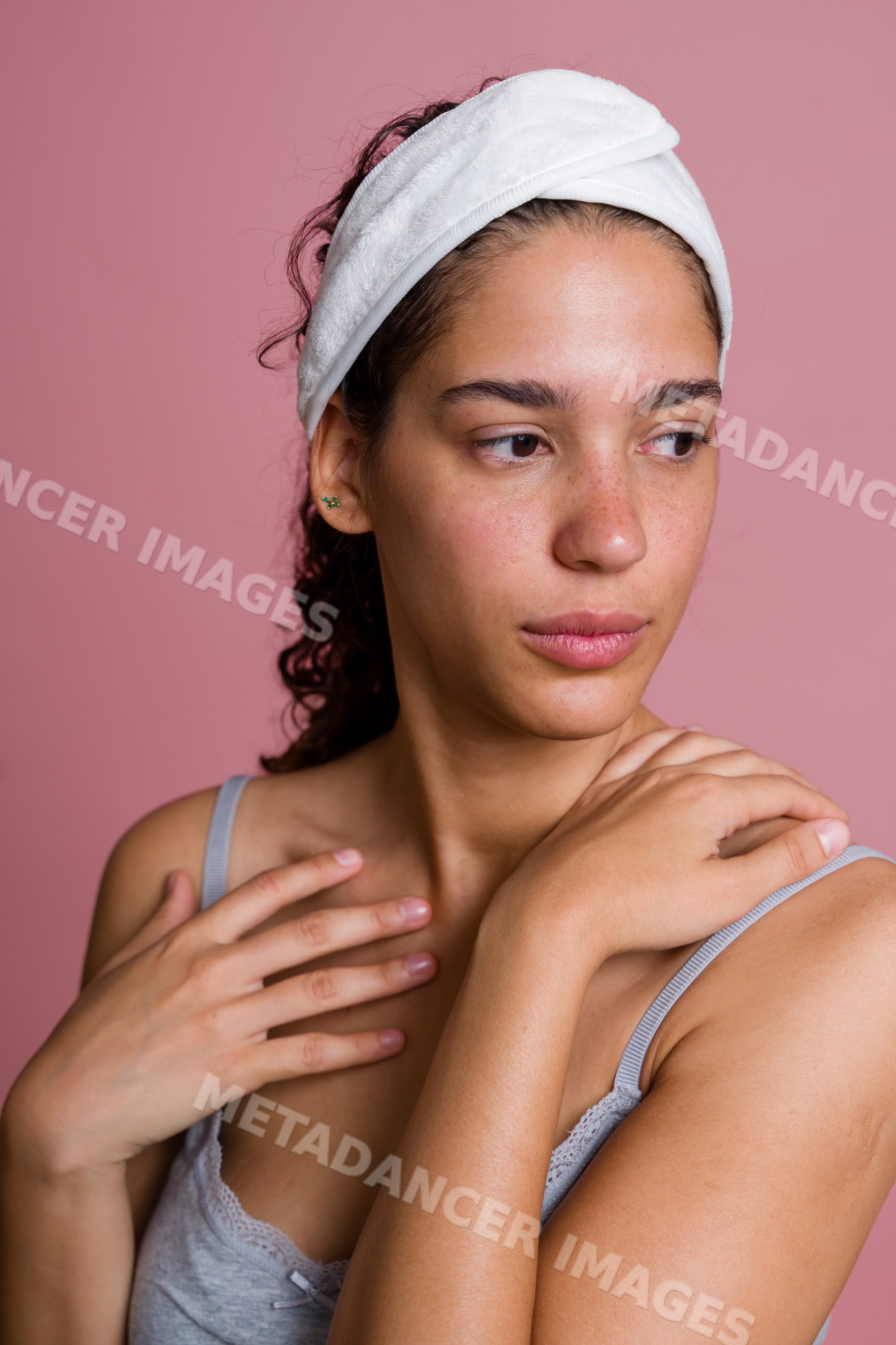 Hispanic woman with natural skin and white headband in beauty shoot