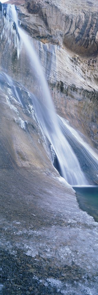 Waterfall cascading over rock formation at lower calf creek falls