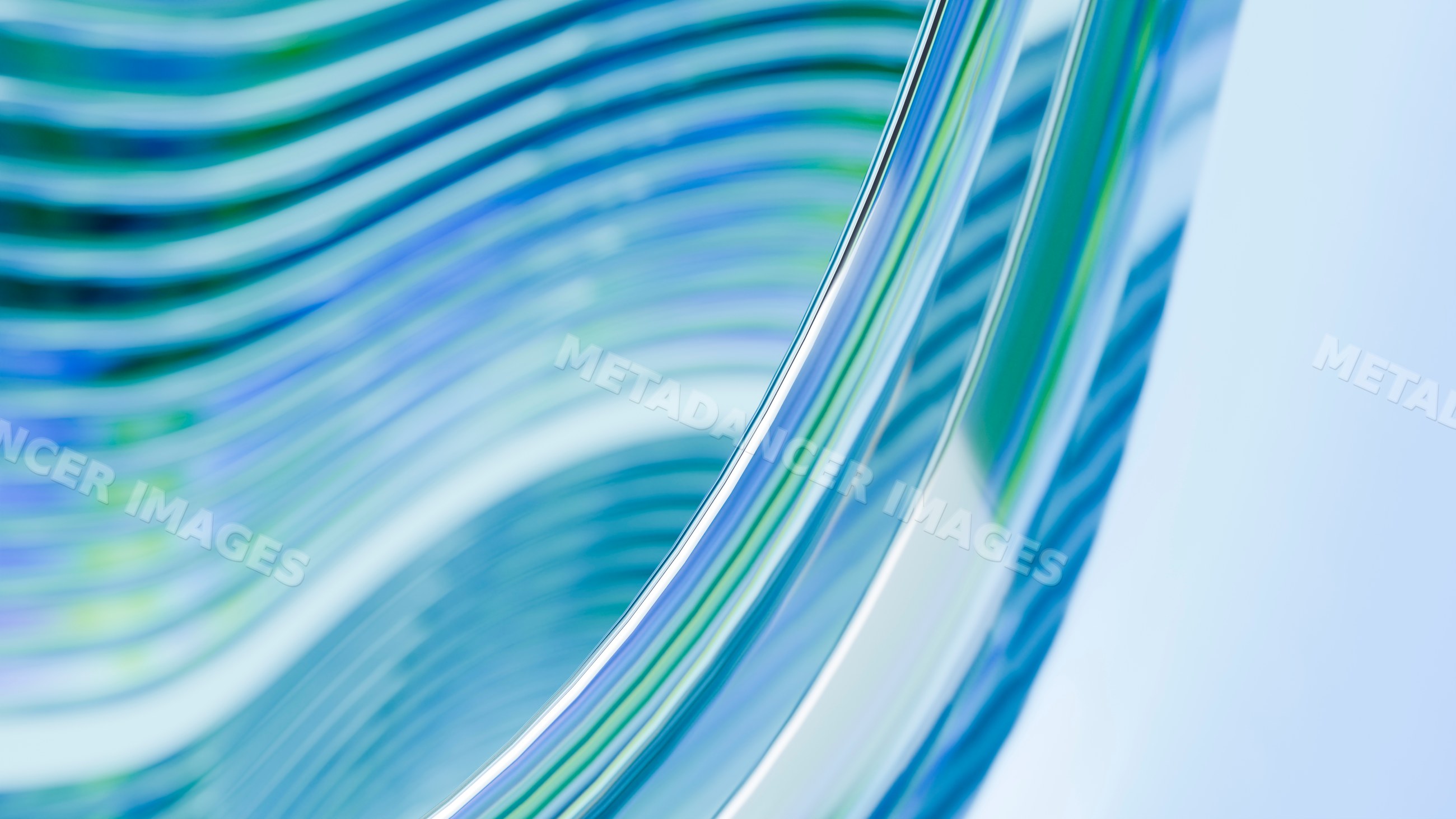 Abstract curved glass waves with blue and green reflections